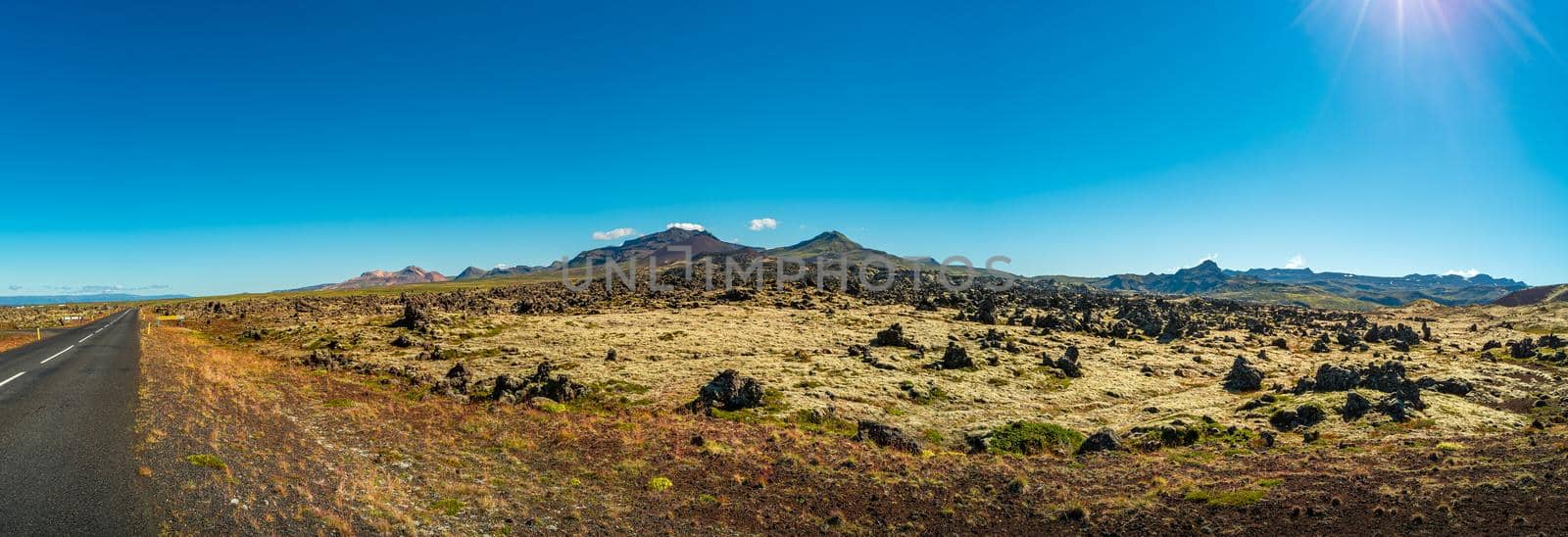 Panoramic view over ancient lava field and lonely road nearby, Snaefellsjoekull National Park, Iceland