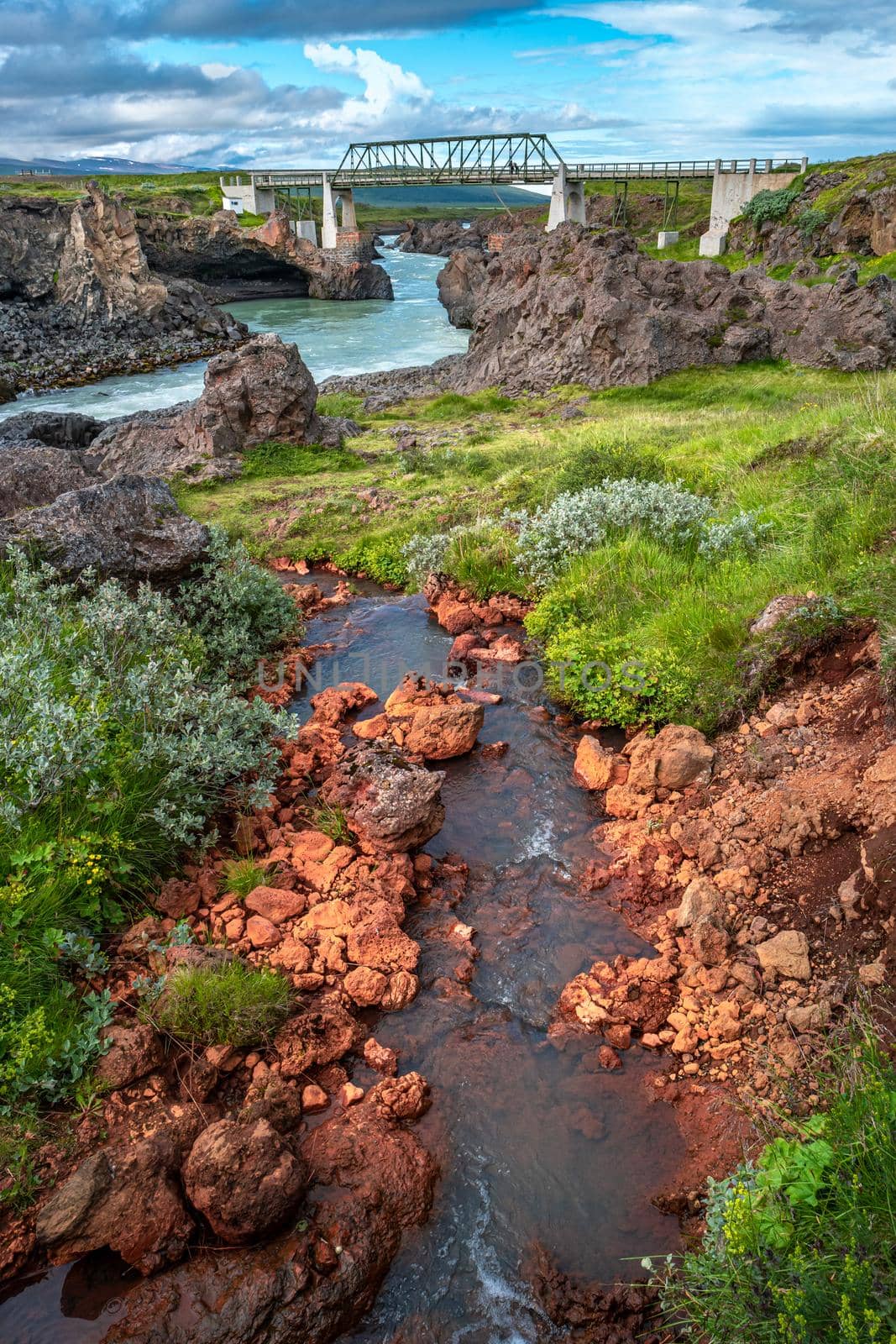 Bridge over a river with powerful waterfall Godafoss in Iceland, summer, scenic view