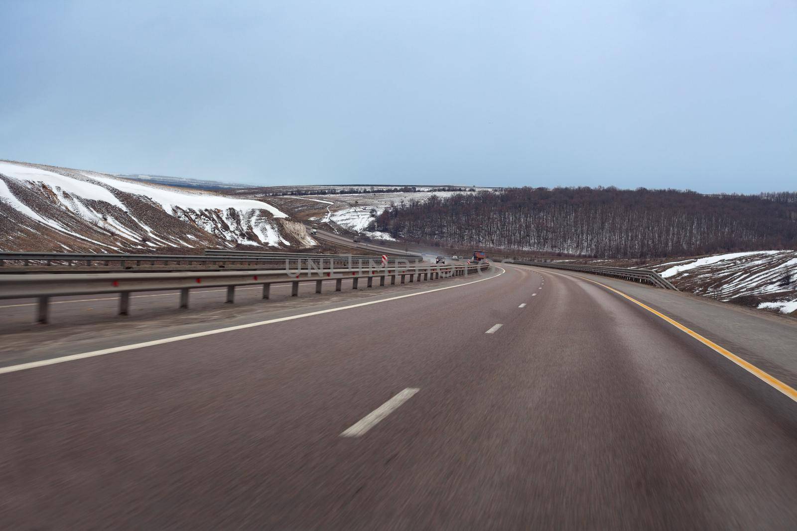 Road trough snowy hills by Angorius