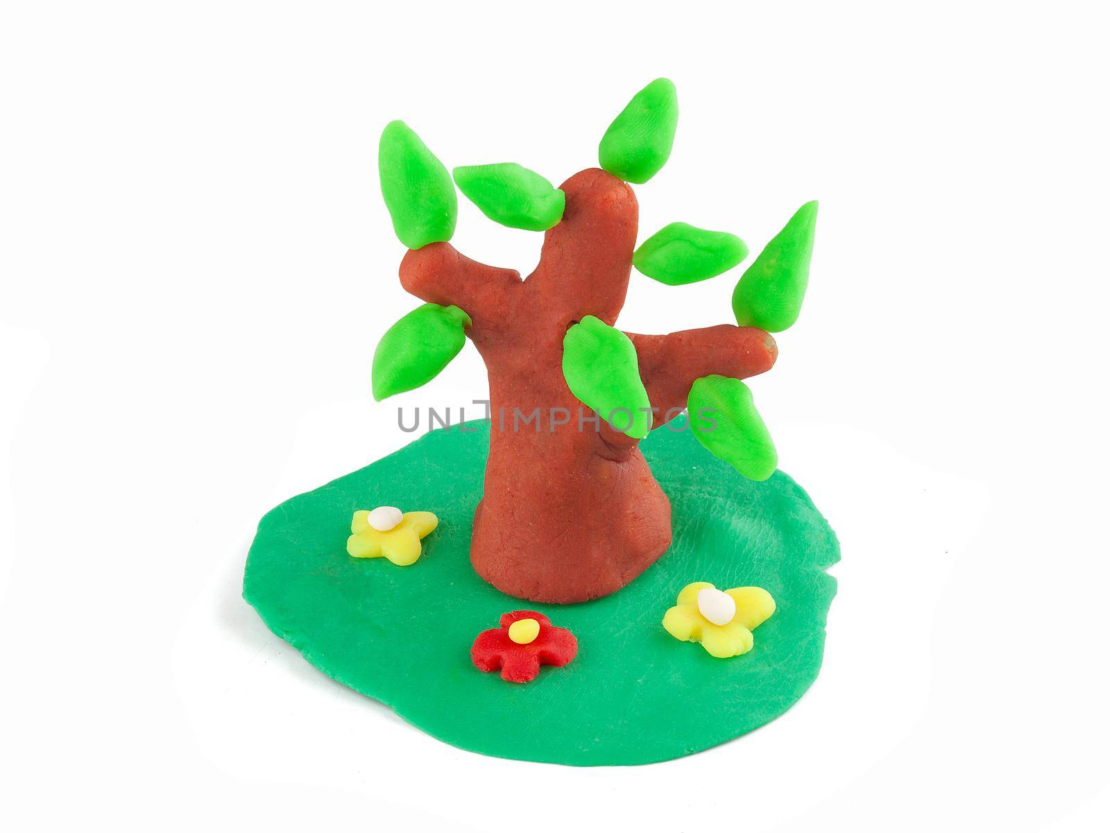 Isolated plasticine tree and meadow on the white