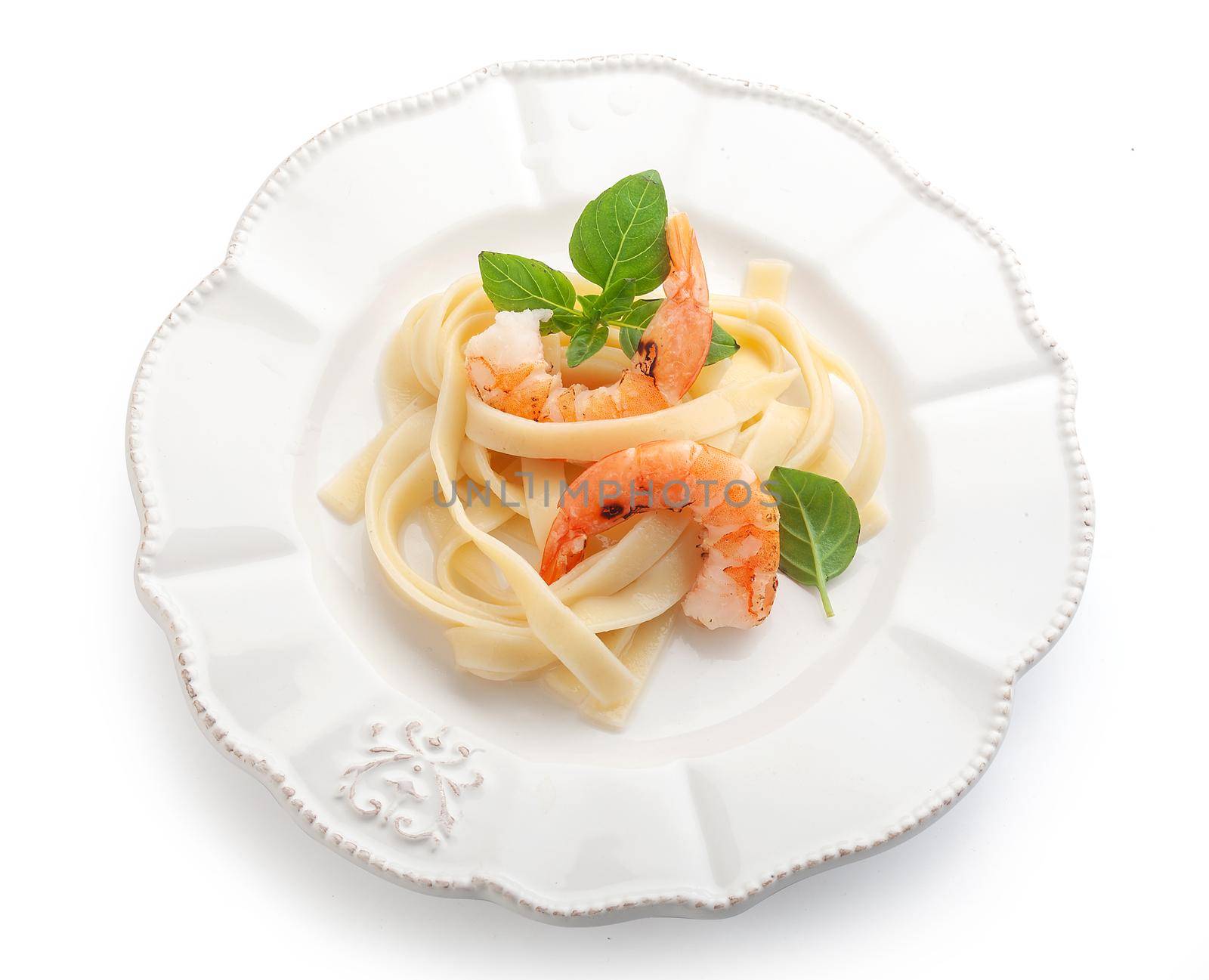 Roasted shrimps with pasta on the plate