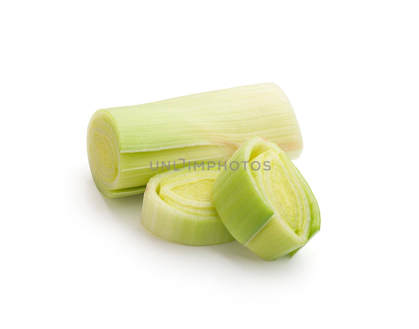 Isolated pieces of fresh green leek on the white background