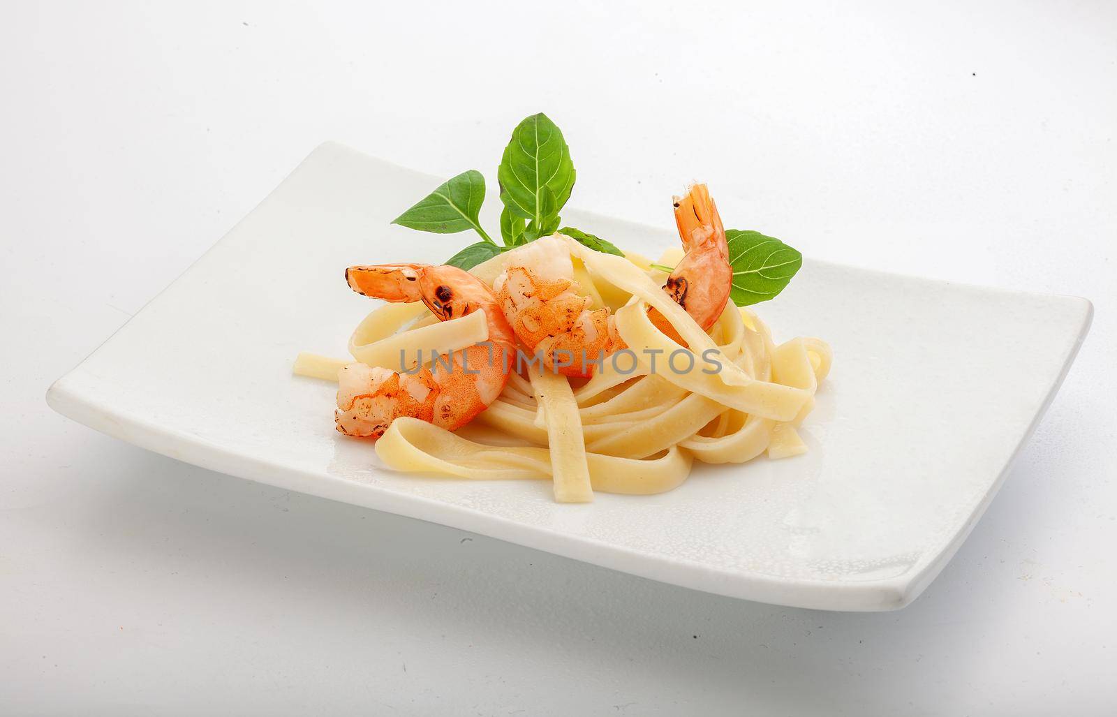 Roasted shrimps with pasta on the plate