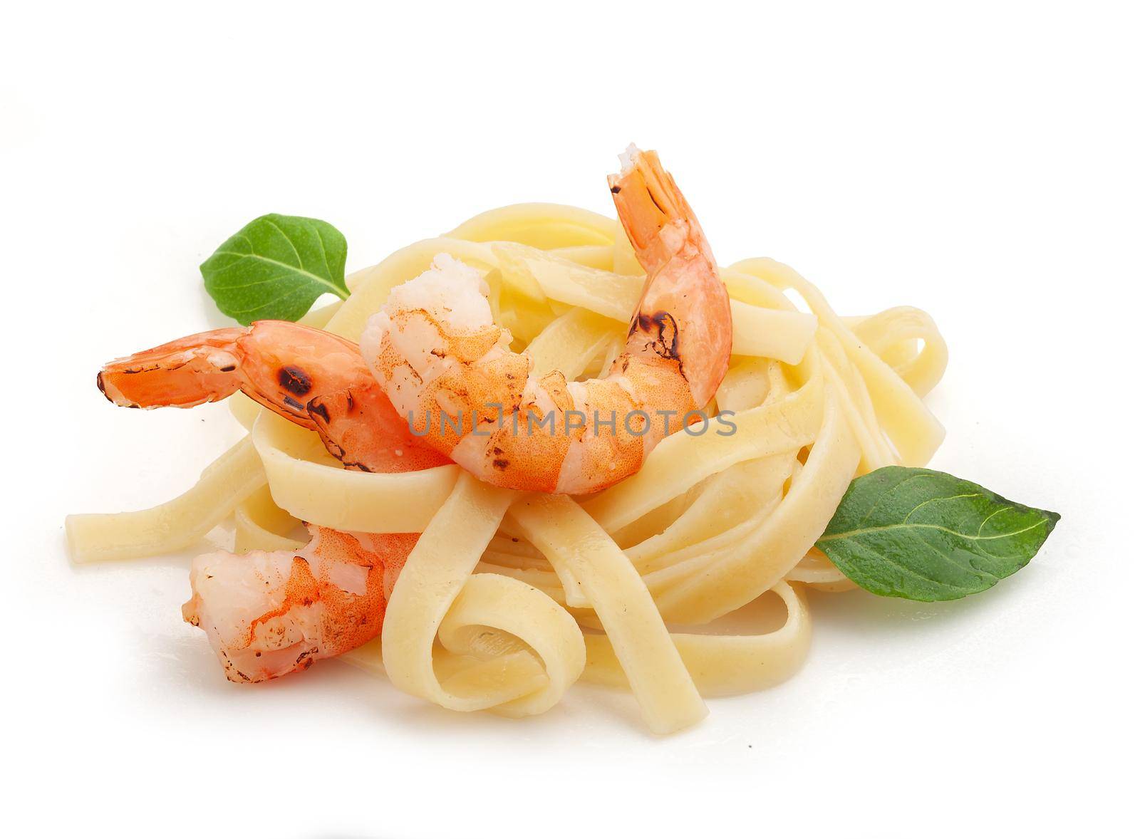 Roasted shrimps with pasta on the plate