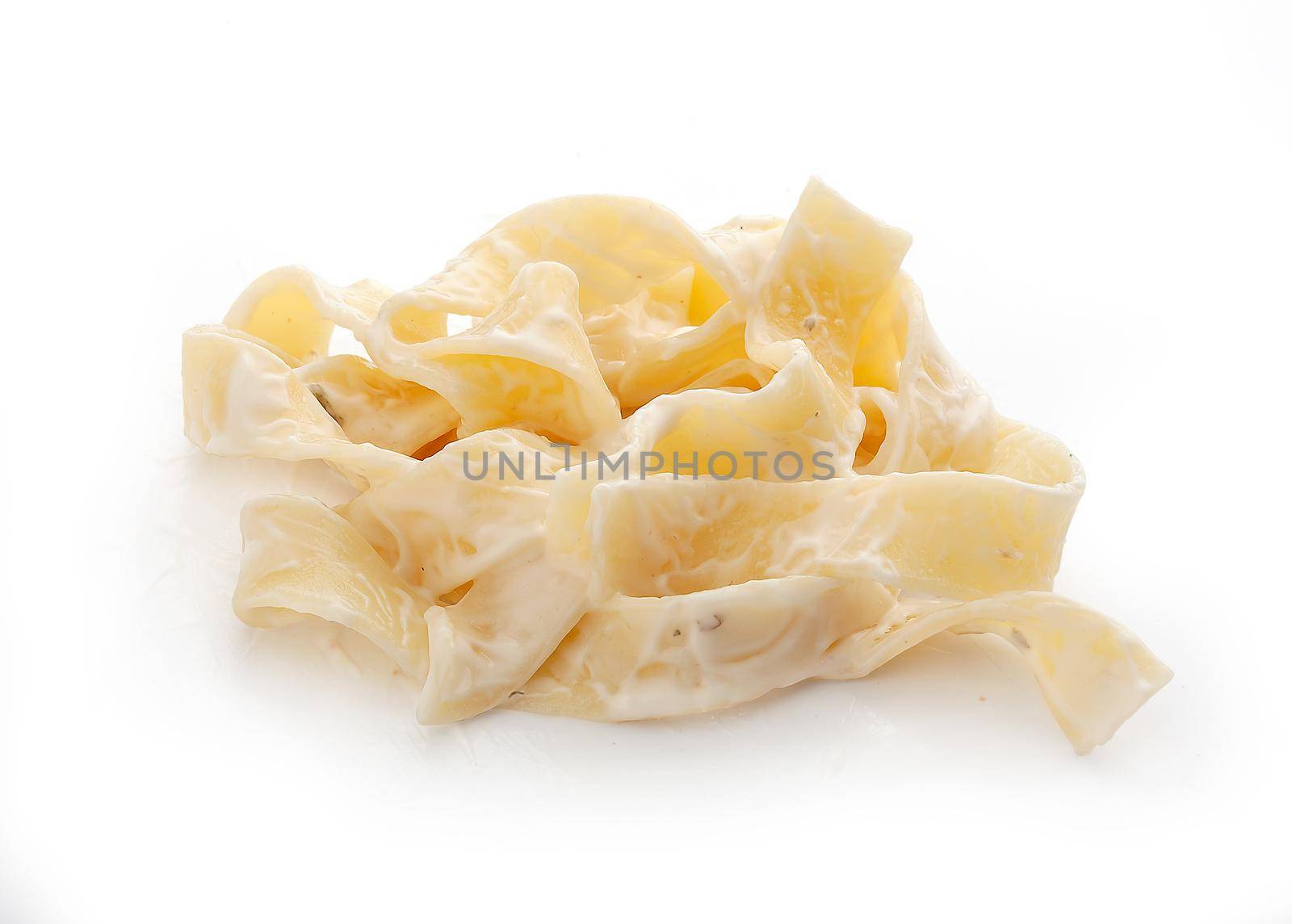 Prepared flat pasta with white sauce on the white background