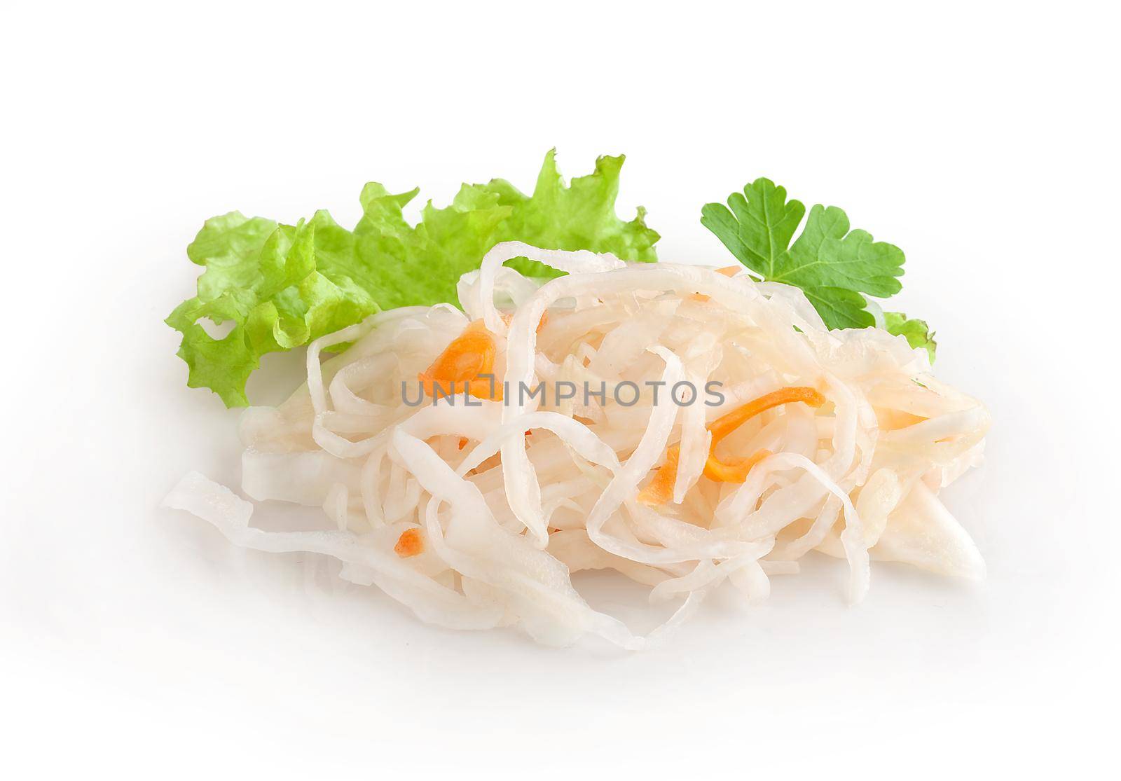 Isoalted handful of sauerkraut with fresh green lettuce leaves and parsley