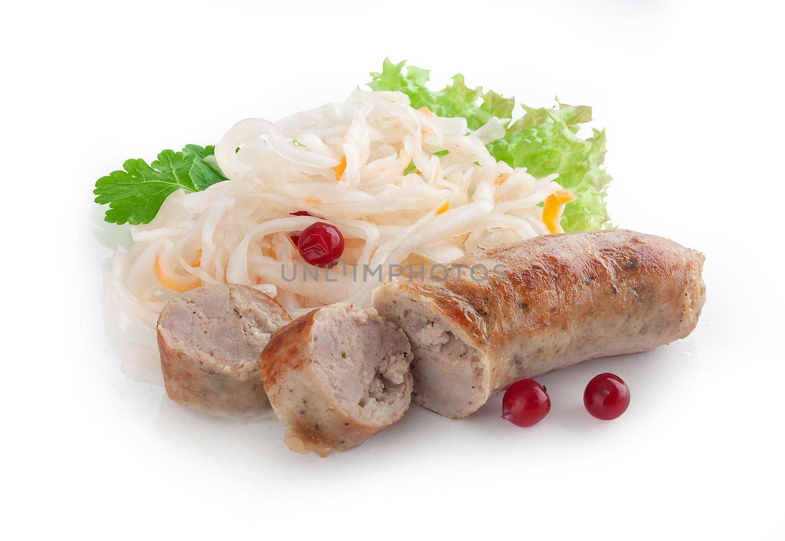 Isolated fried sausage with some sauerkraut, cranberry and fresh green parsley