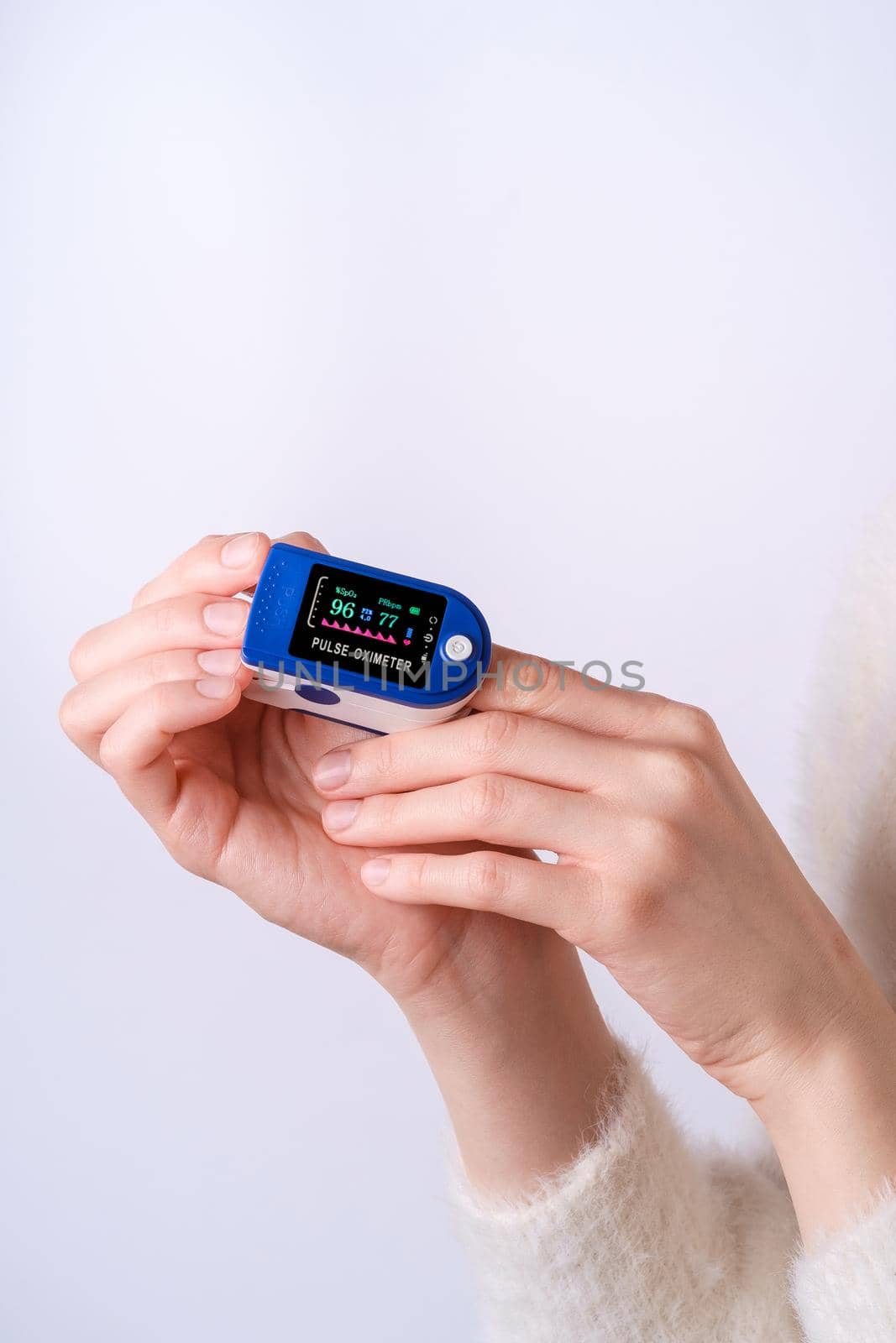 Person using pulse oximeter device on finger, healthcare monitoring concept