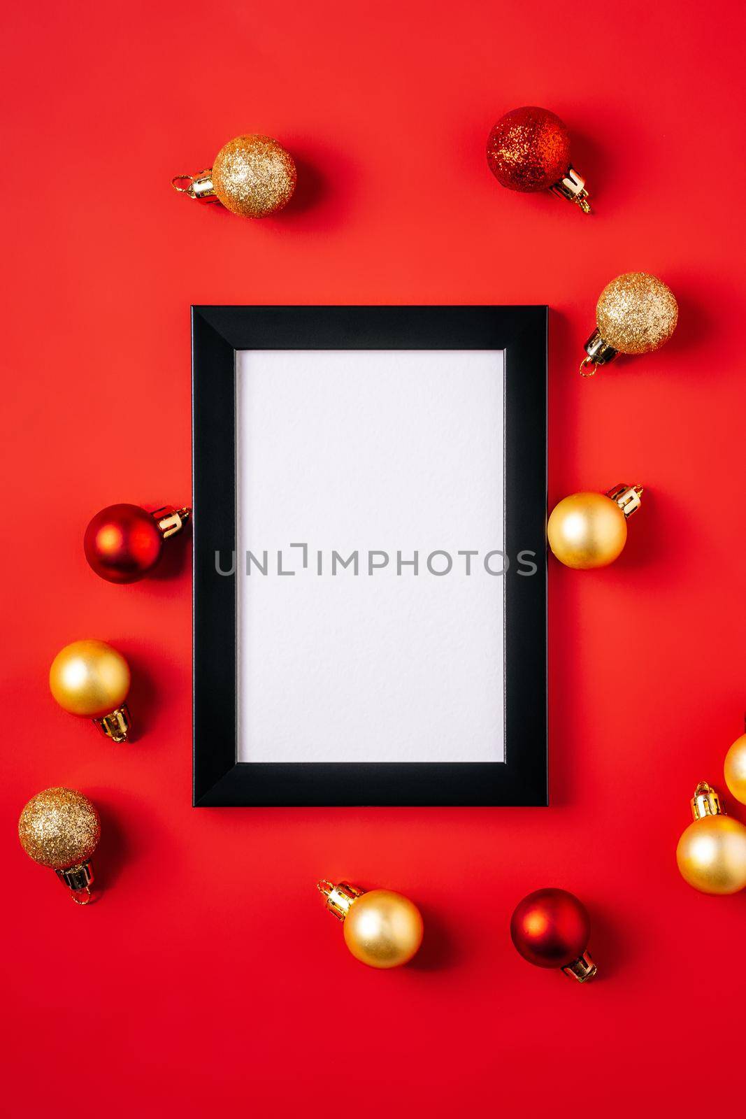 Christmas composition with picture frame mockup. Red and golden ornament and baubles decorations.