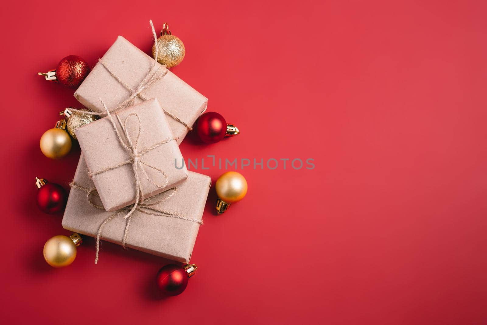 Christmas composition. Red and golden ornament and baubles decorations with zero waste gift box. Copy space