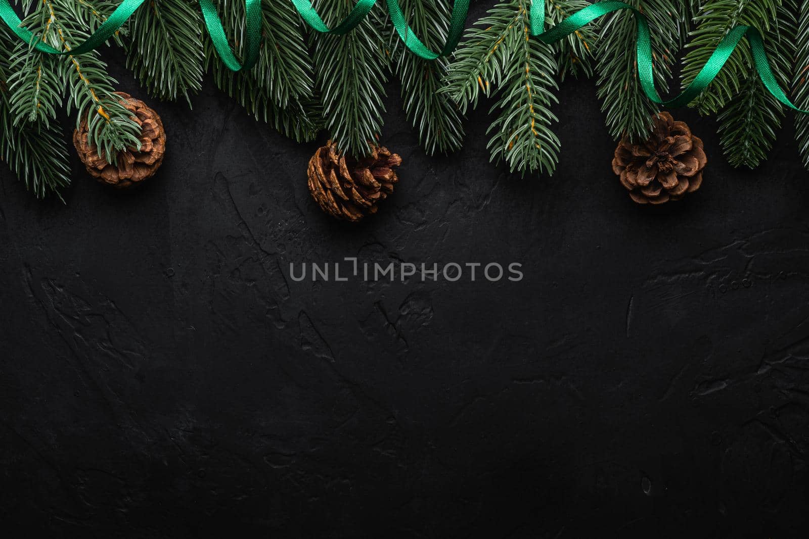 Christmas holidays composition. Green ribbon, fir-tree and pine cones. Copy space