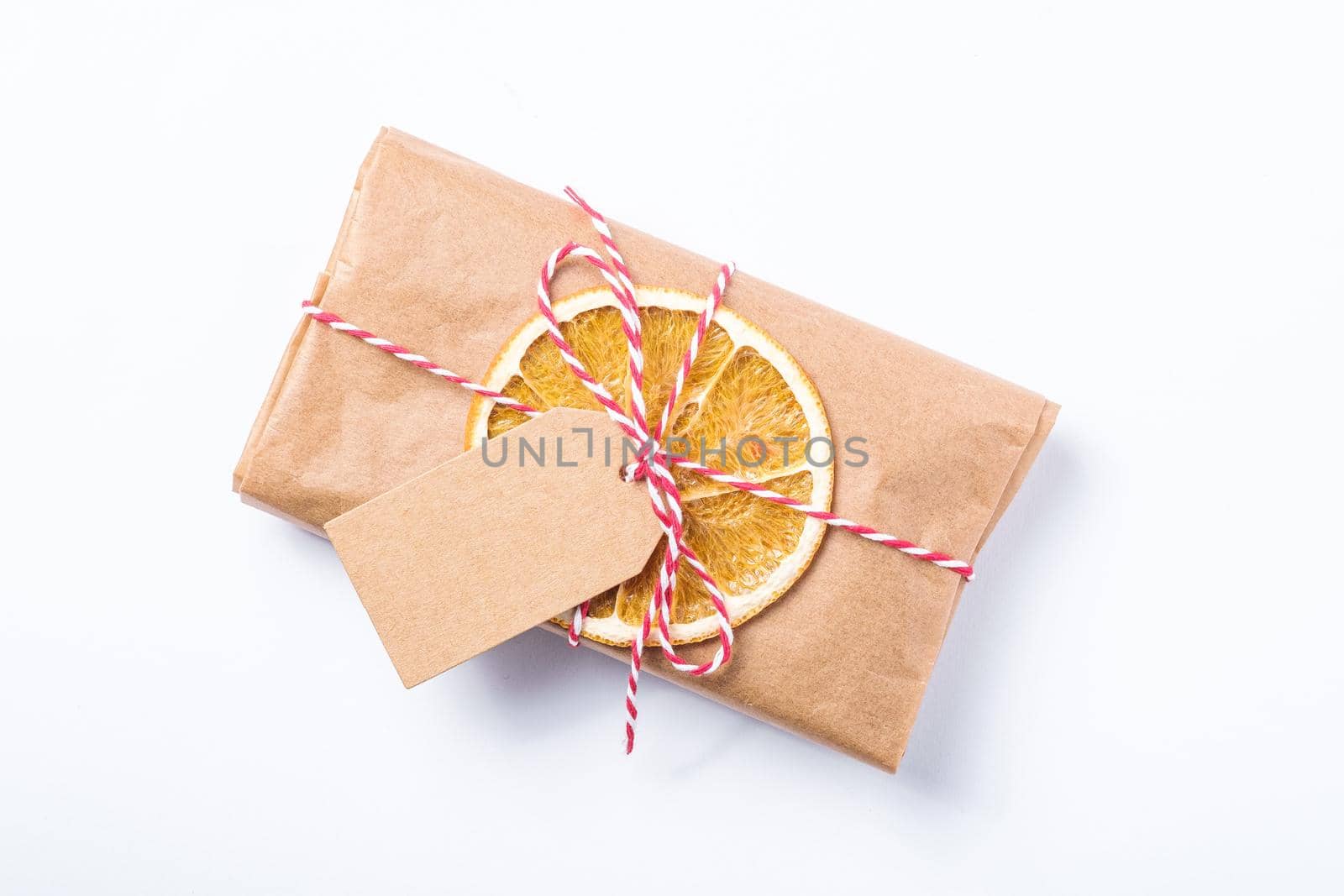 Christmas holidays zero waste paper gift wrapping with dried fruit and tag