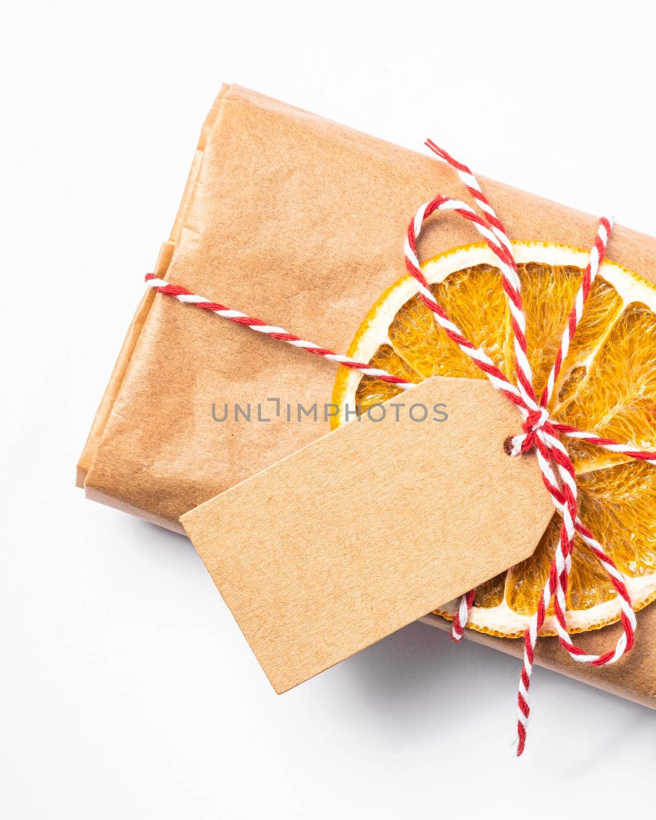 Christmas holidays zero waste paper gift wrapping with dried fruit and tag by Frostroomhead