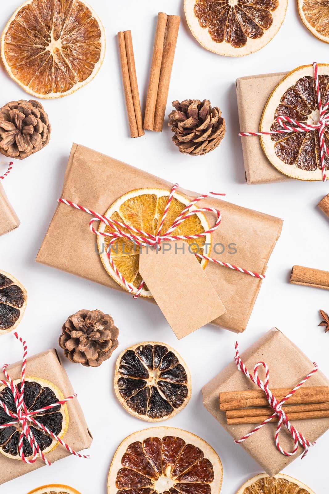 Christmas holidays zero waste paper gift and box wrapping with dried fruit slices, cinnamon and anise by Frostroomhead