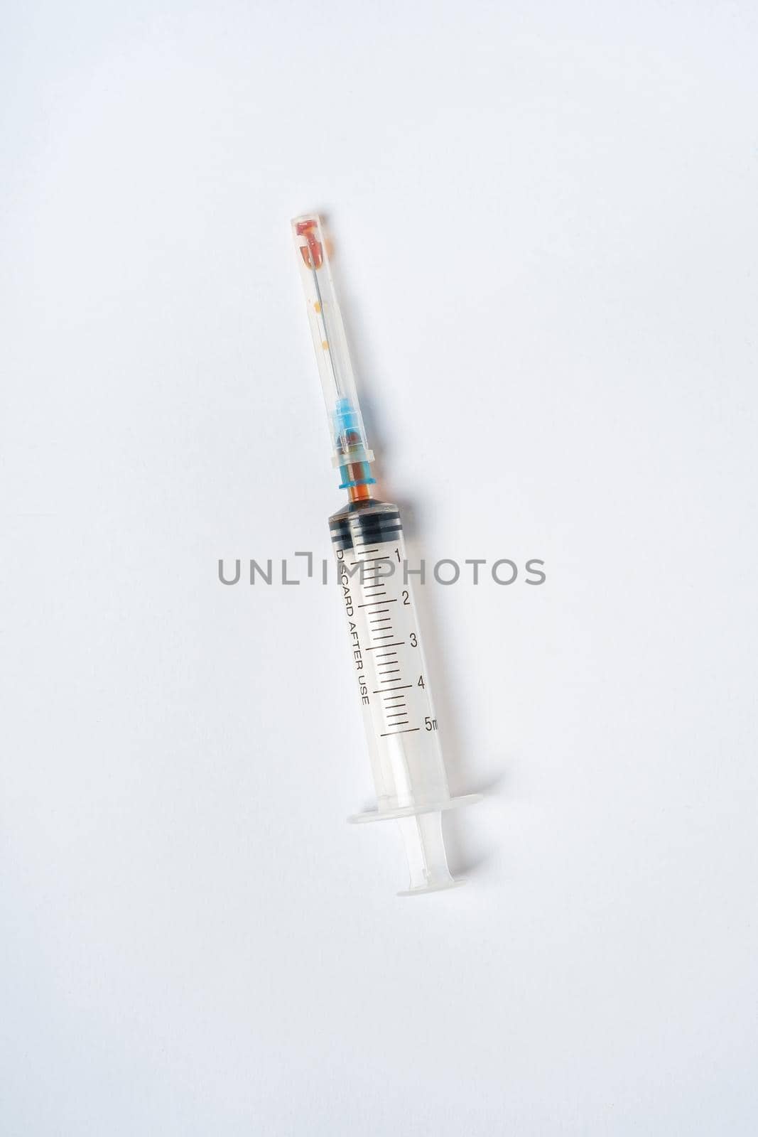 Dirty used plastic syringe, isolated