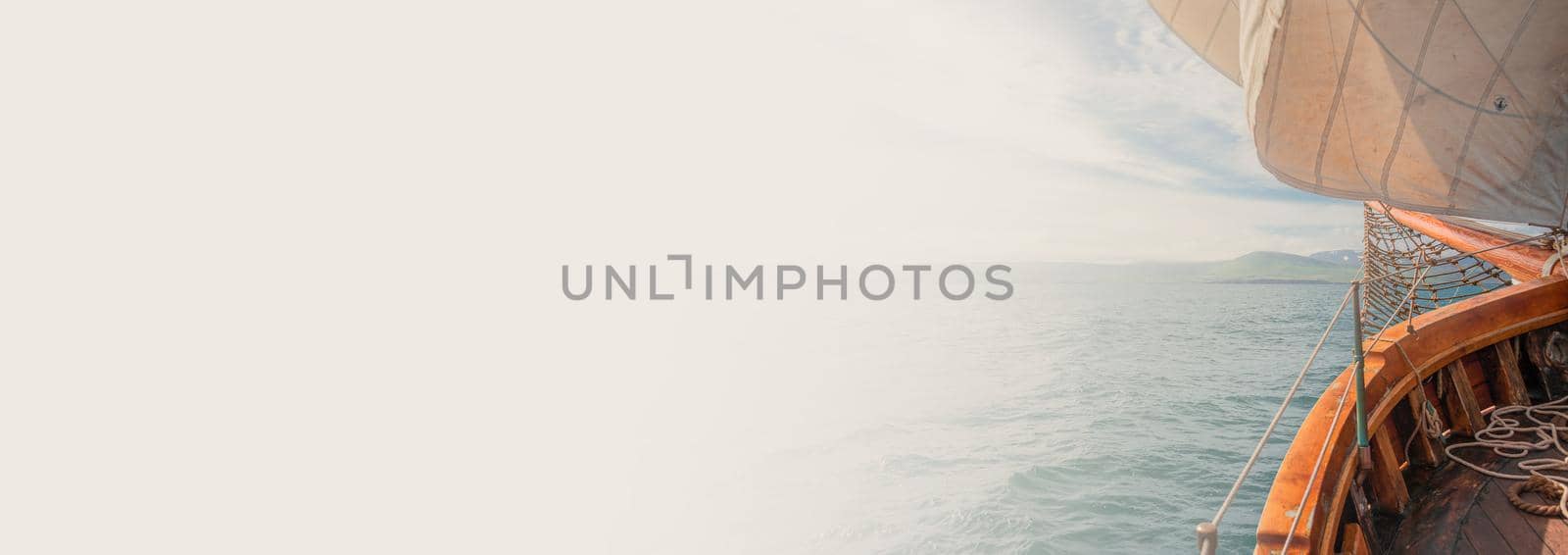 Banner with an old sailing boat towards dreams and adventures, with copy space for text. Concept travel, freedom and adventure, nomadic lifestyle