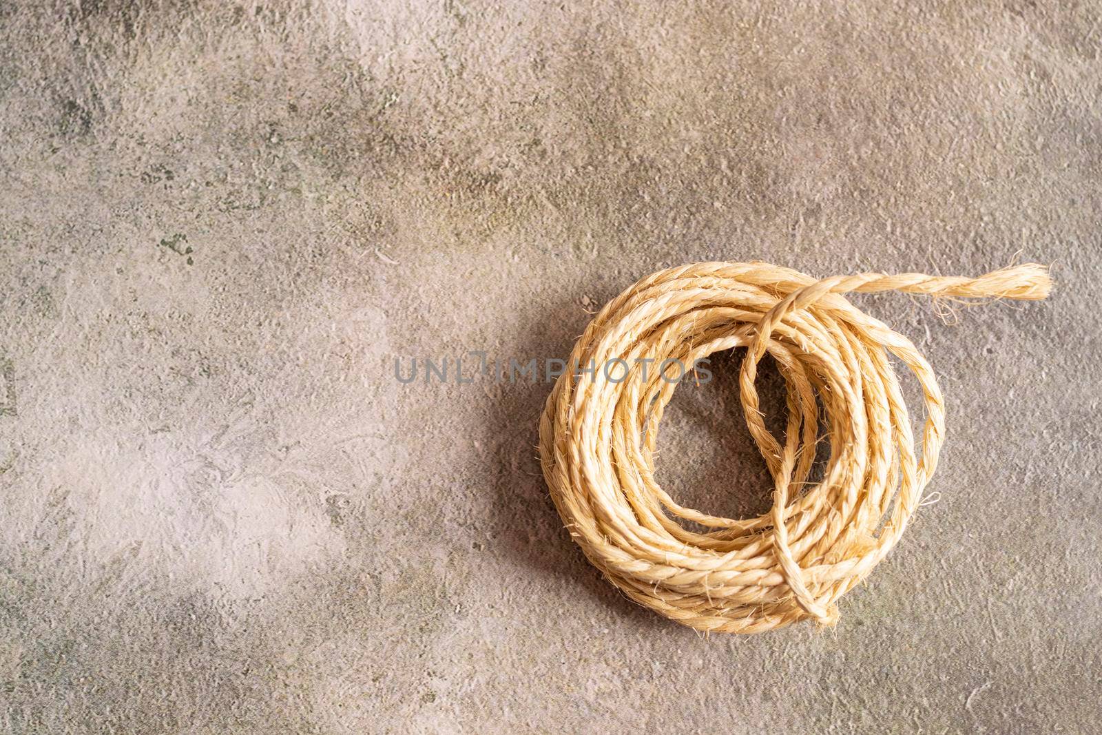 View of a roll of rope on a golden background