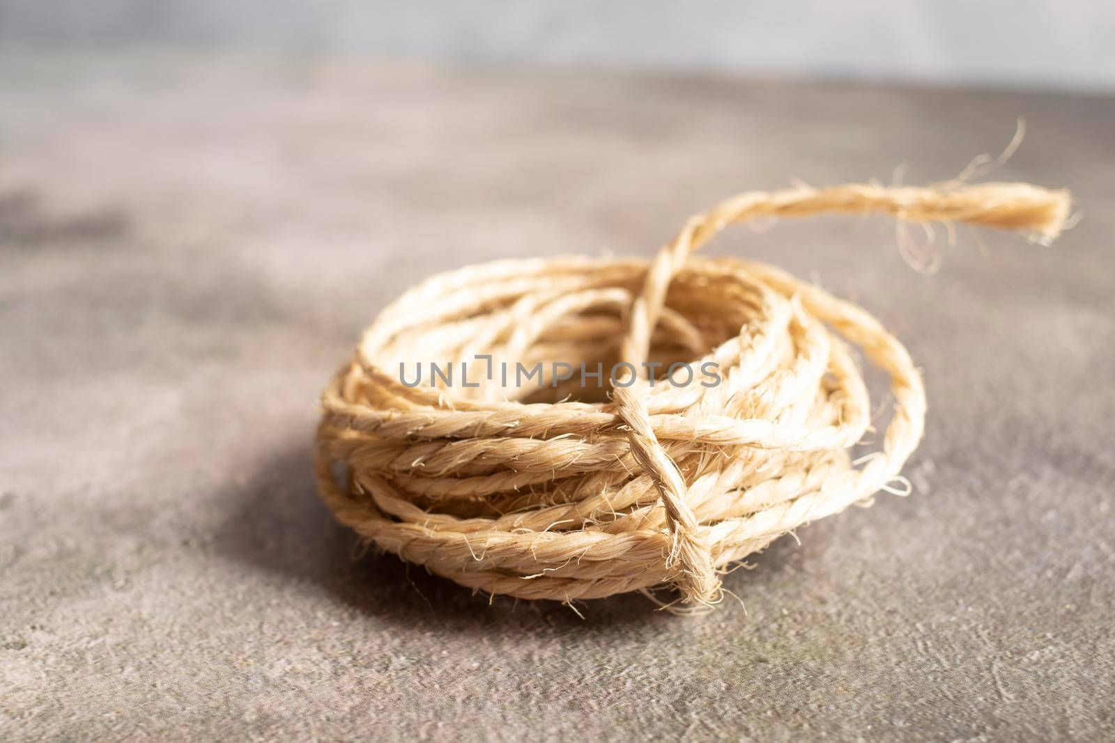 View of a roll of rope on a golden background