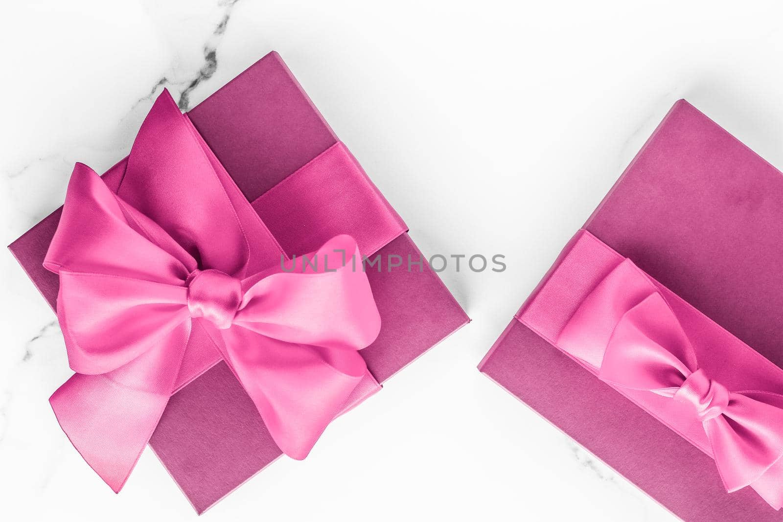 Birthday, wedding and girly branding concept - Pink gift box with silk bow on marble background, girl baby shower present and glamour fashion gift for luxury beauty brand, holiday flatlay art design