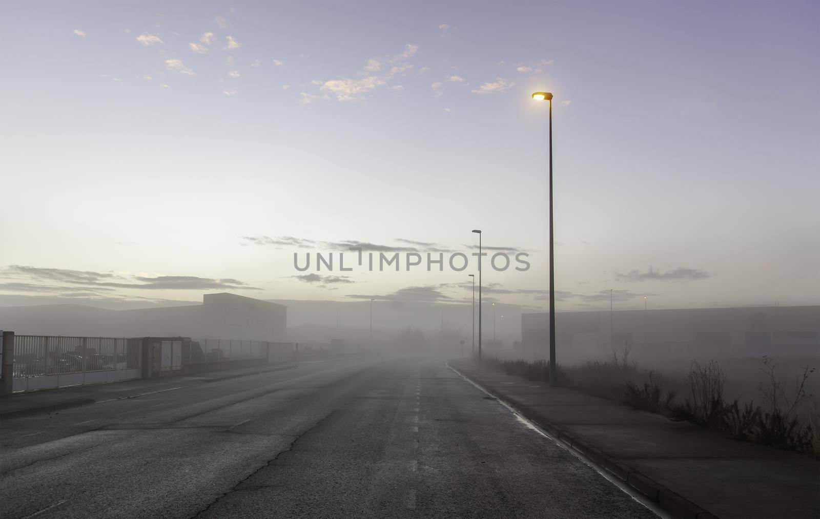 Detail of industrial zone in the city, on a fair day and fog in winter