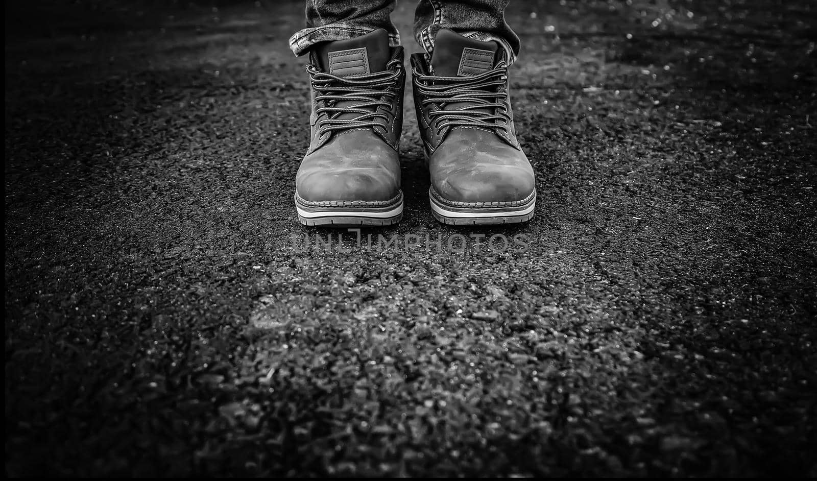 Men's boots in a forest by esebene