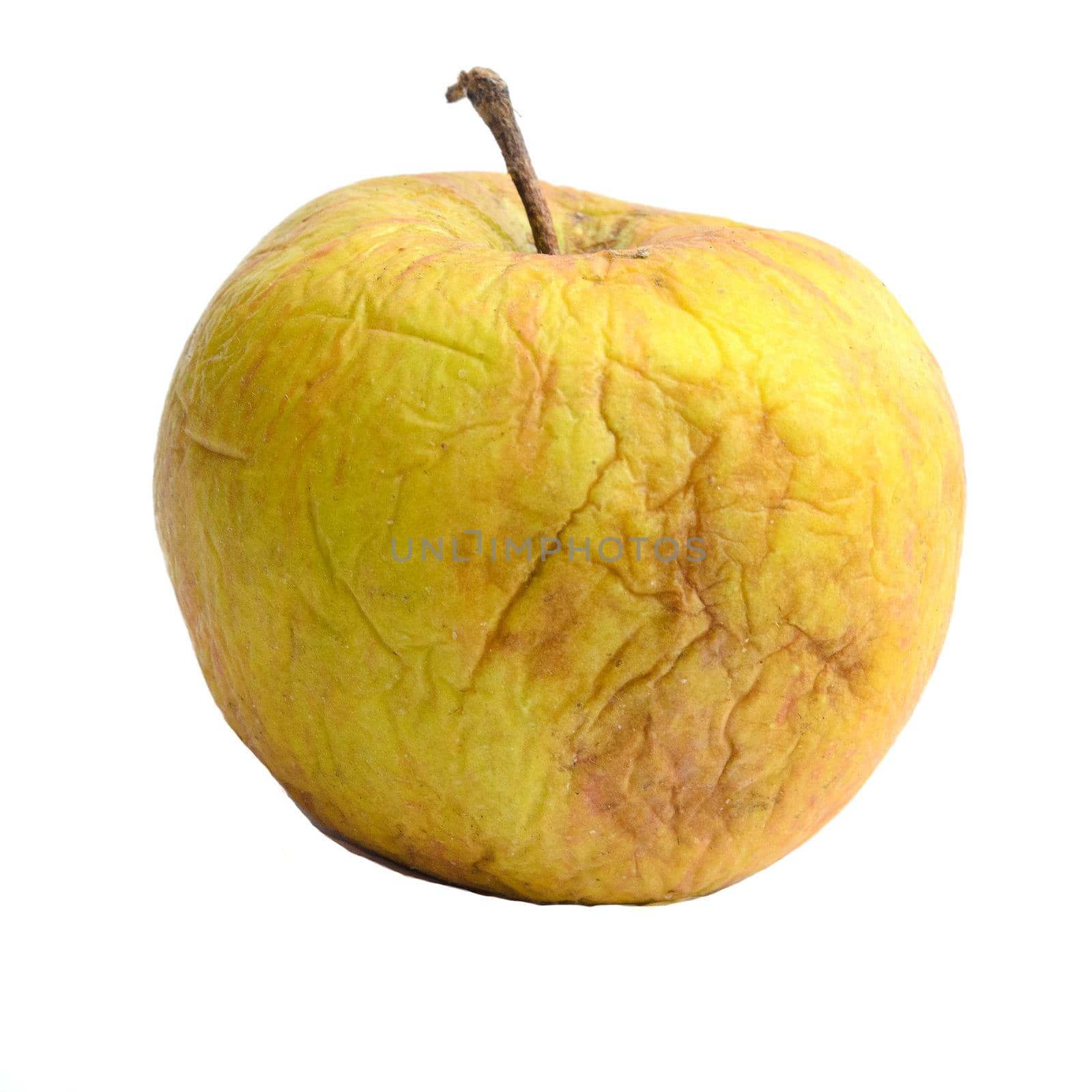 Yellow withered apple isolated on white background