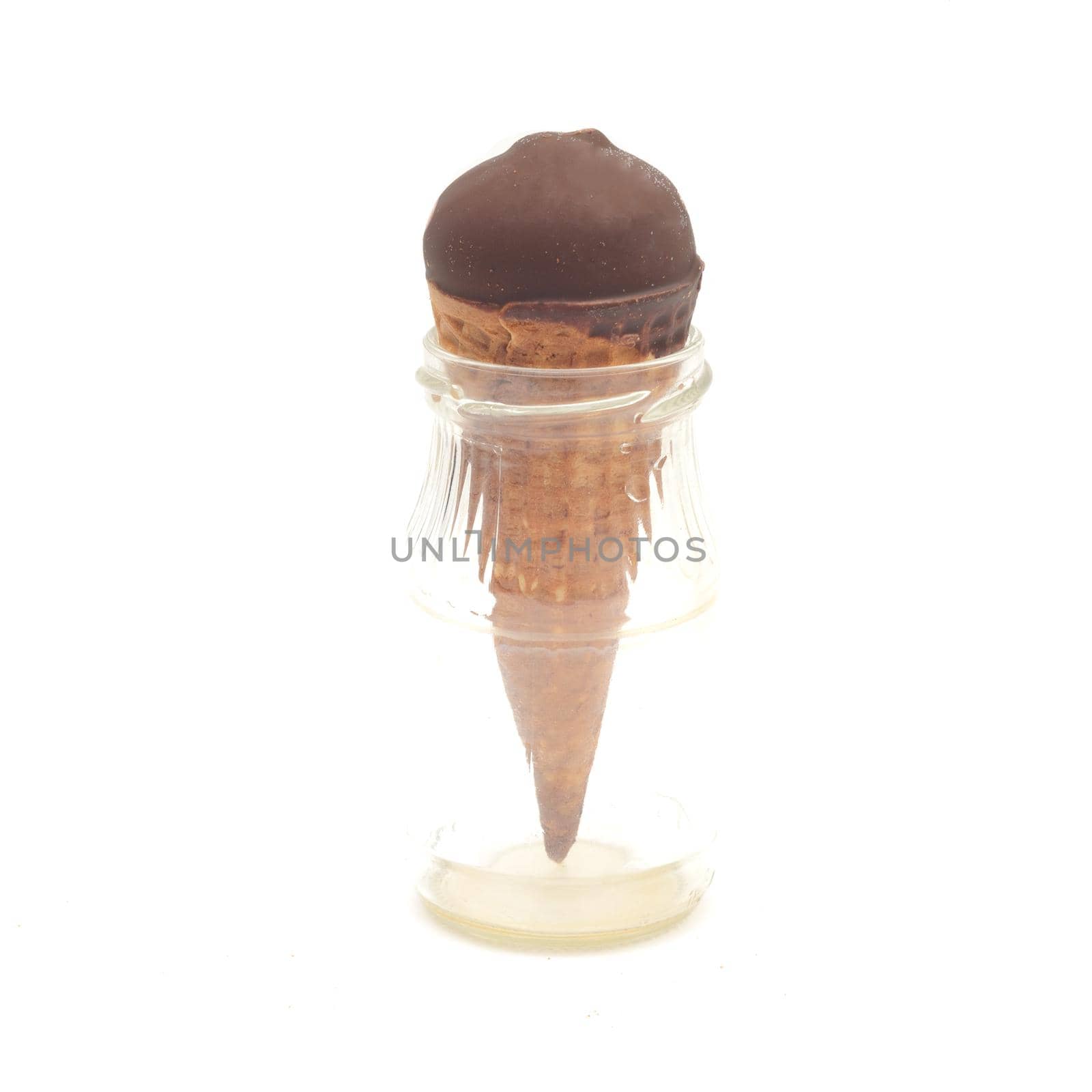Chocolate ice-cream cone in small glass bottle isolated on white background.