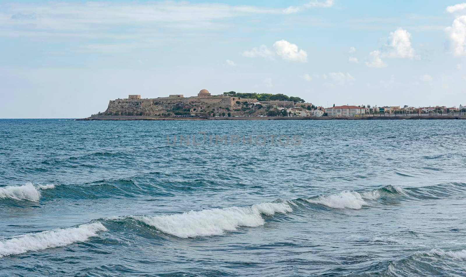 Seascape. Fortress and old town on the coast (Greece, Crete, Rethymno). Stock photo.