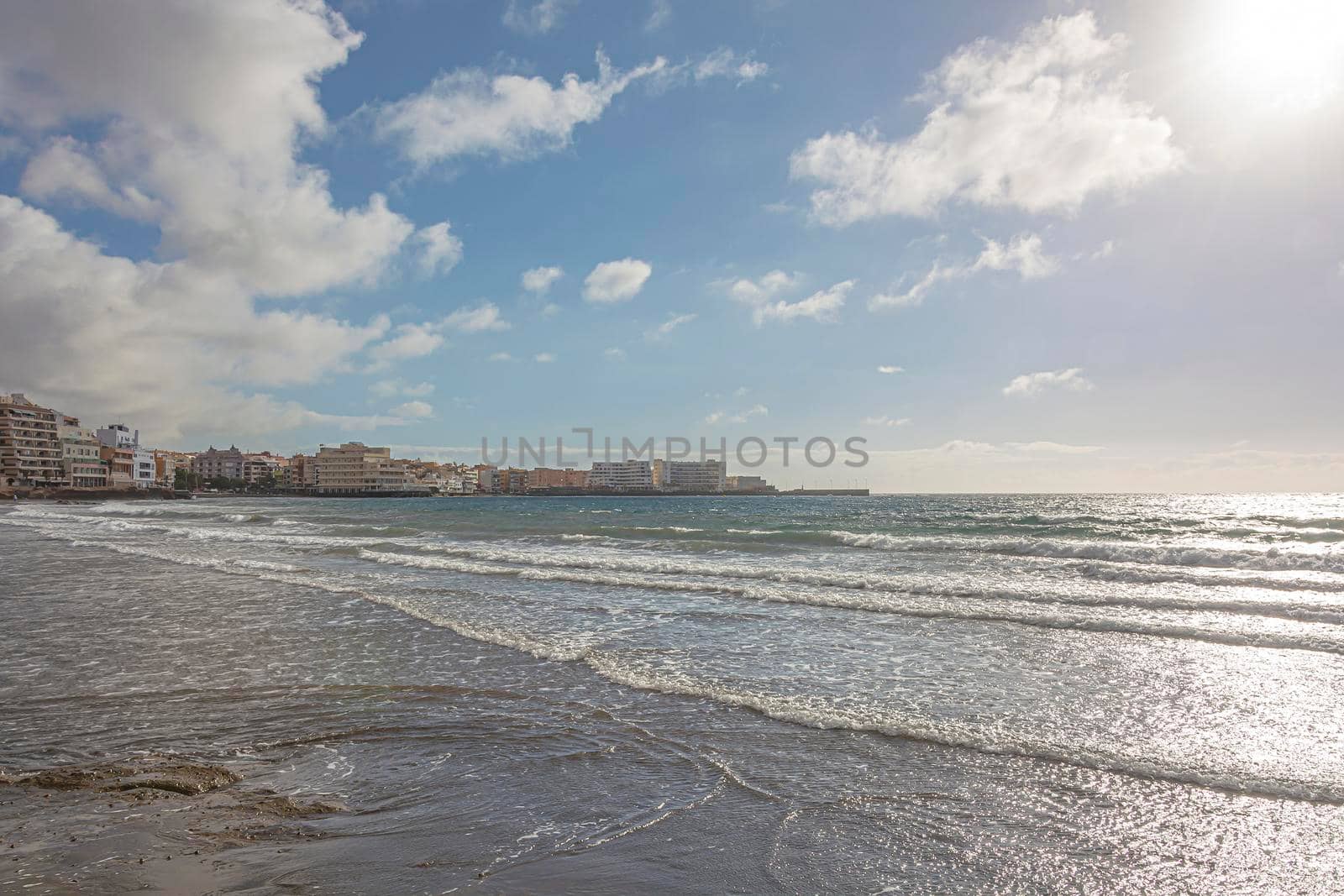 Landscape. Resort town on the ocean (El Medano, Spain, Tenerife island). Stock photo.