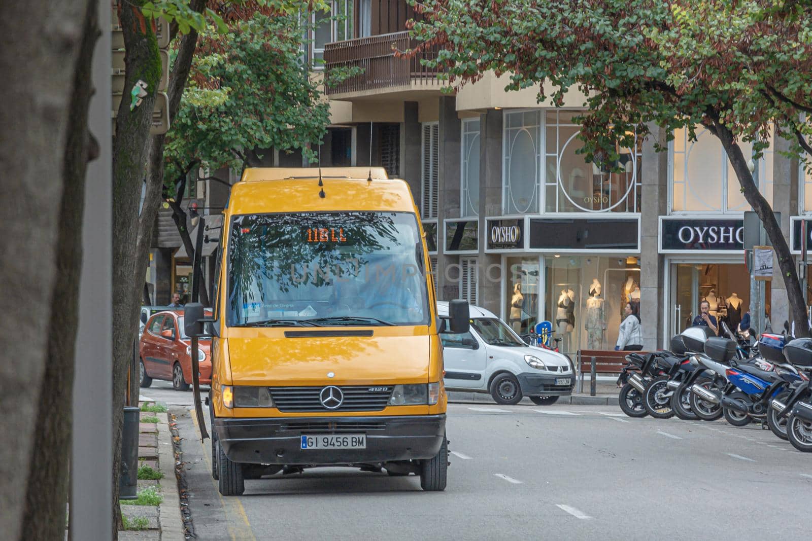 Girona, Spain - April 03, 2021: Minibus route on the city street. Stock photo.