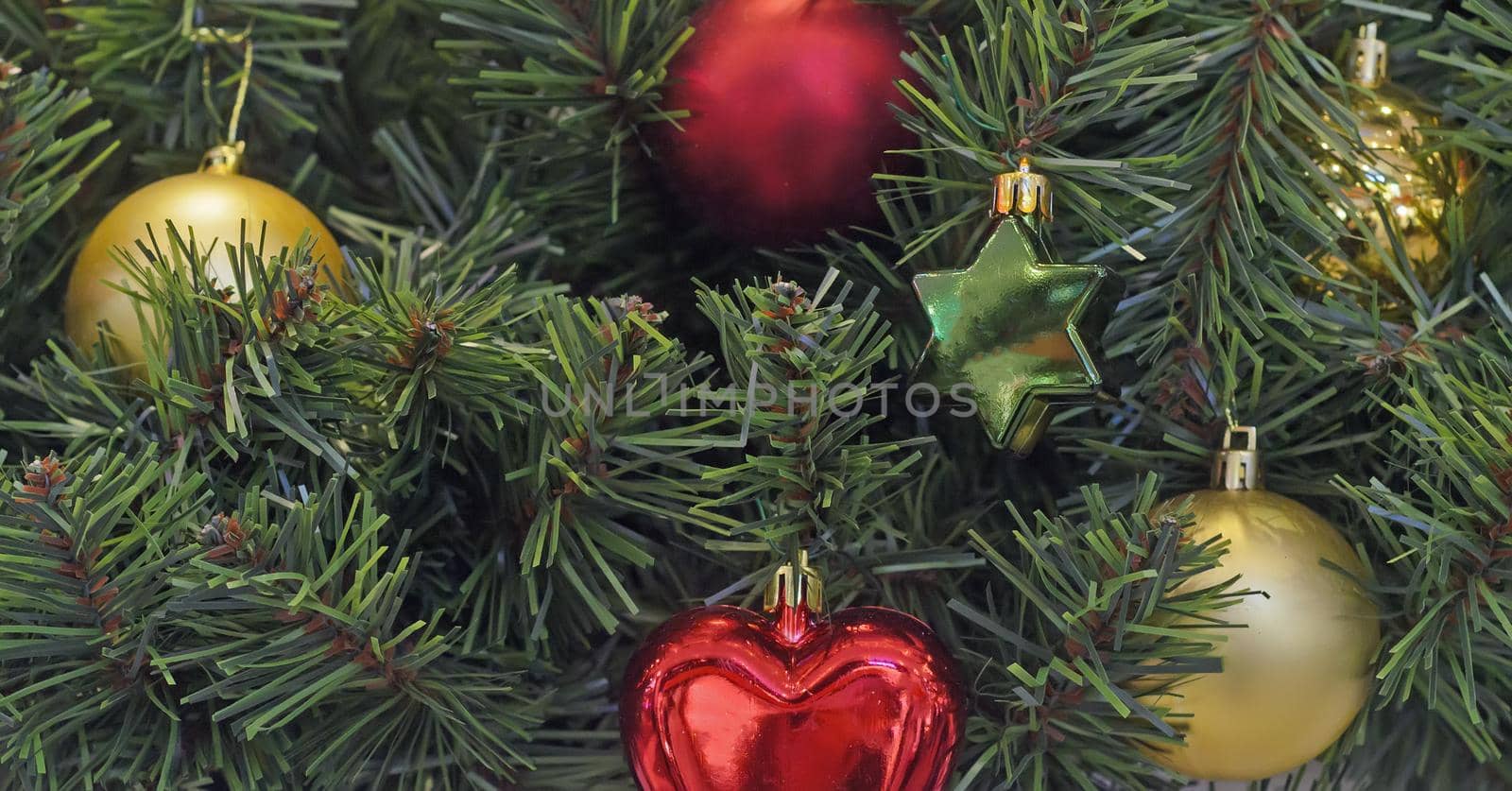 Christmas and new year hanging decoration.Multicoloured christmas balls and star toy on tree branches background