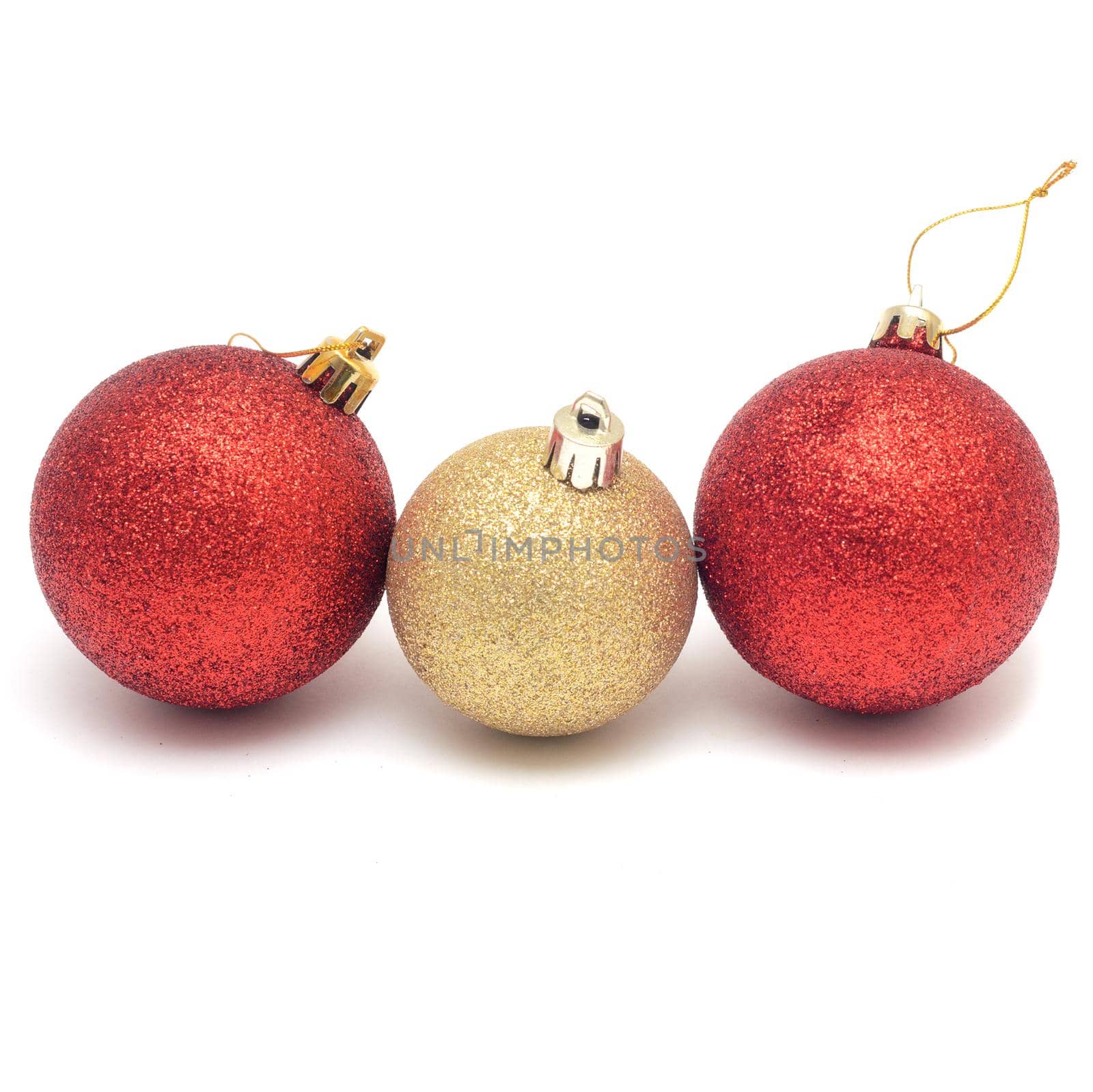 Line from two red and one golden Christmas balls isolated on white background. by andre_dechapelle