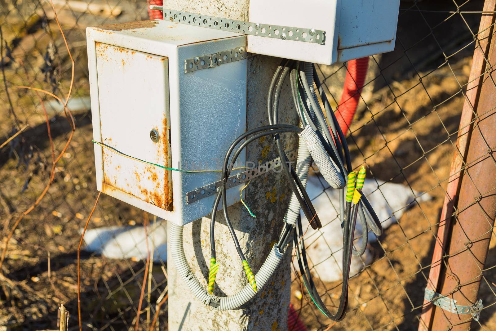 Junction box for connecting electrical wires. Attached to the lamppost. Close-up