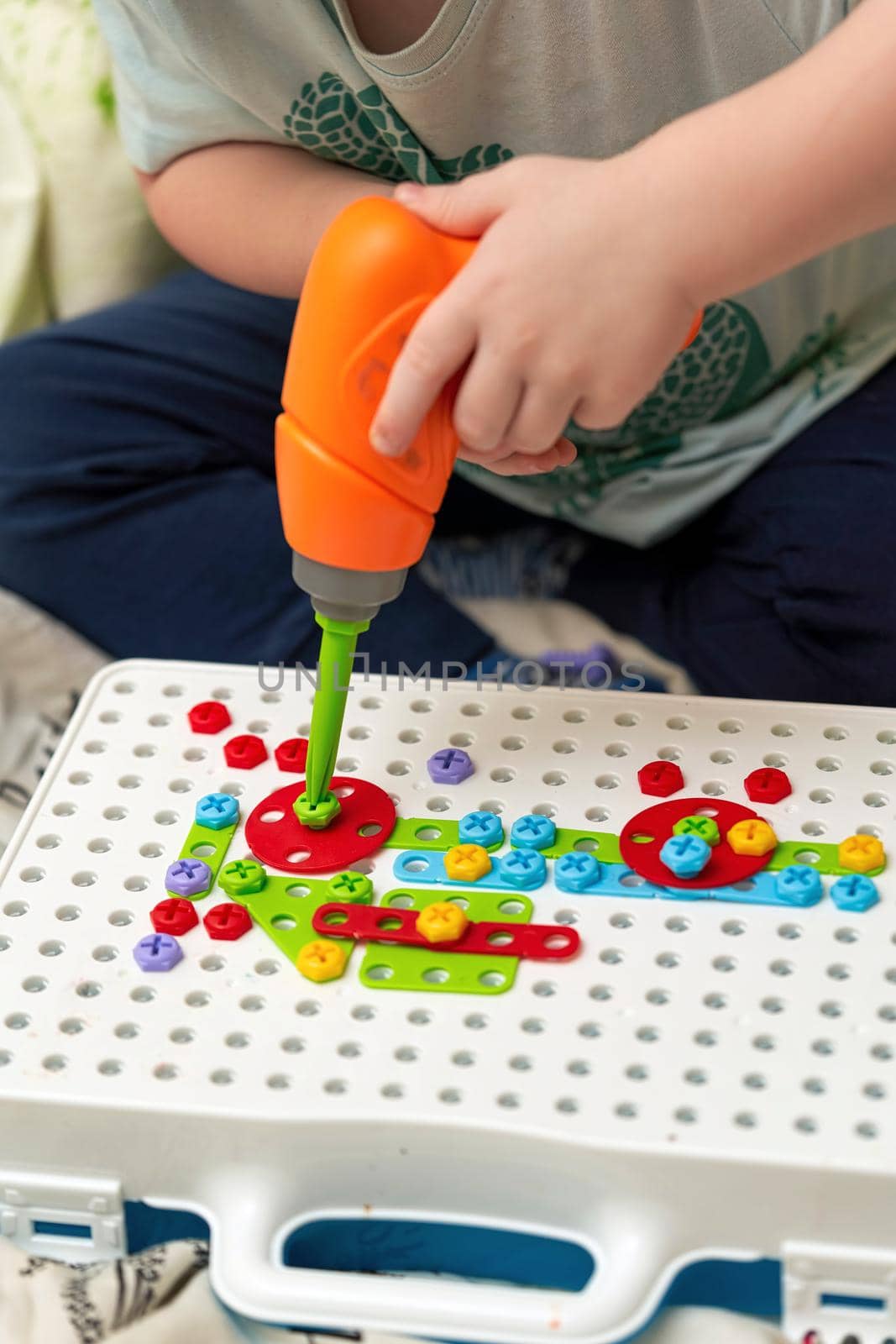 A child plays a toy screwdriver collecting designer by vizland