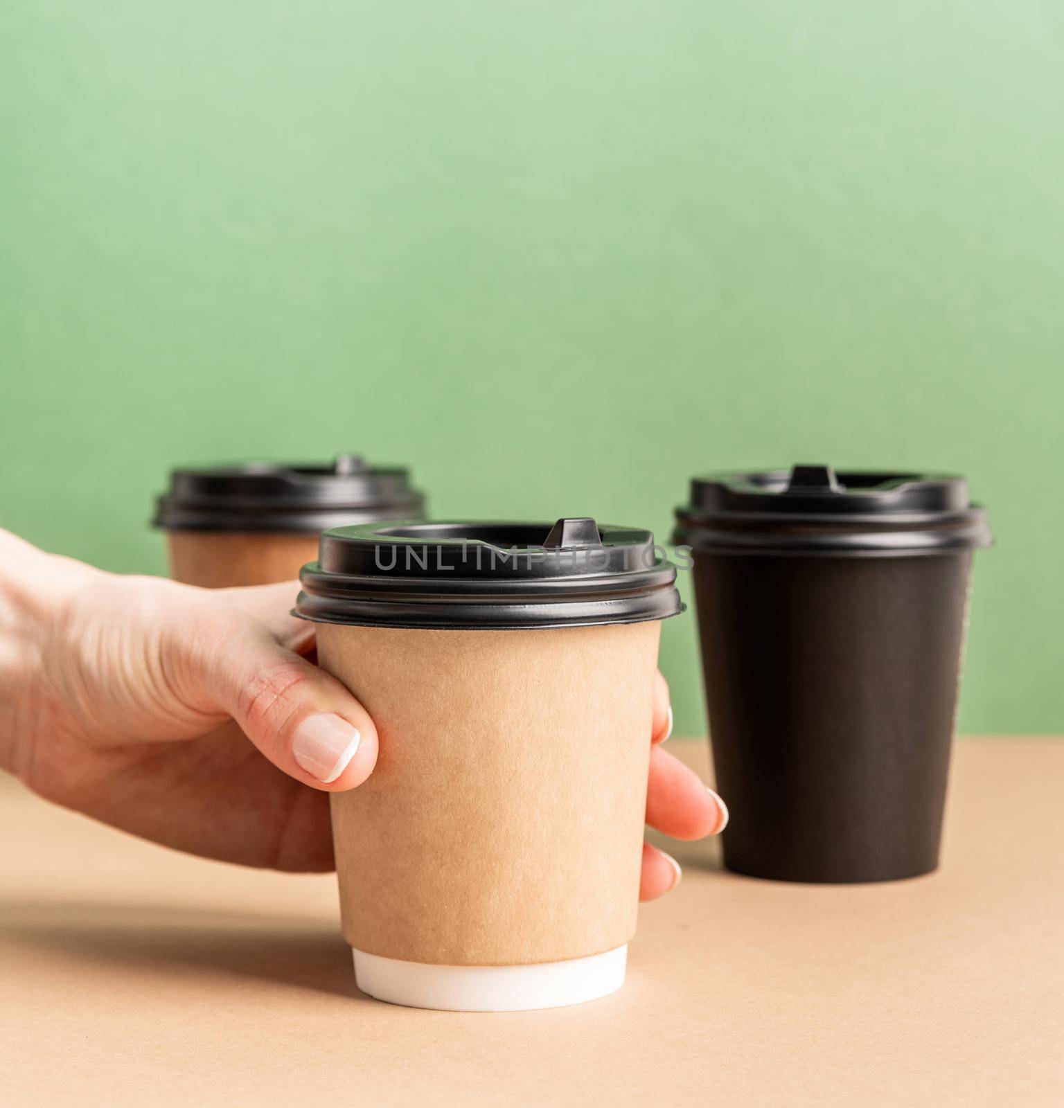 Eco friendly zero waste disposable tableware. Black takeaway paper coffee cups mock up on green and brown background