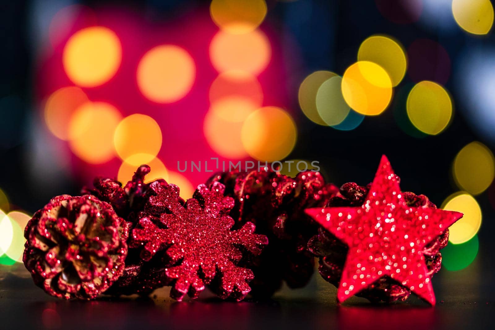 Decorations and ornaments in a colorful Christmas composition isolated on background of blurred lights. by vladispas
