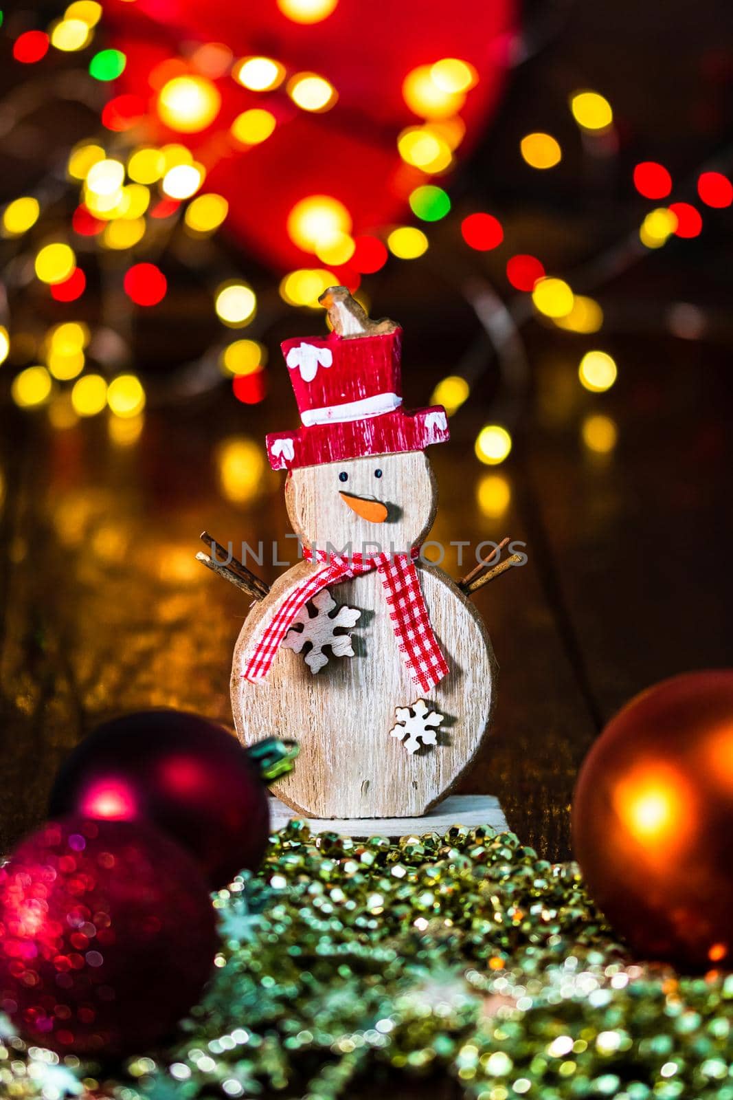 Decorations and ornaments in a colorful Christmas composition isolated on background of blurred lights. by vladispas
