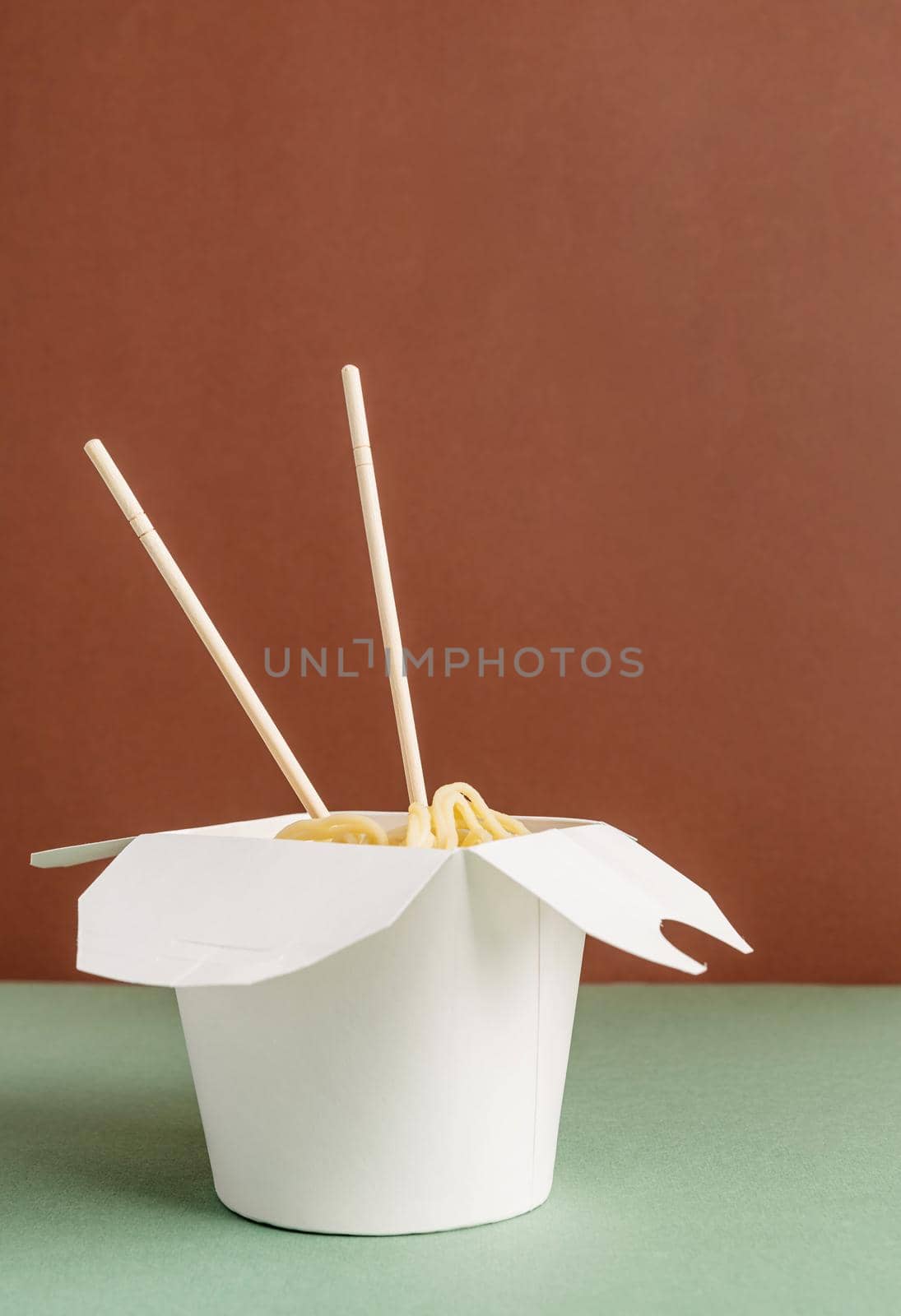 Zero waste and ecology concept. Opened WOK paper box with noodles and chopsticks for mock up design