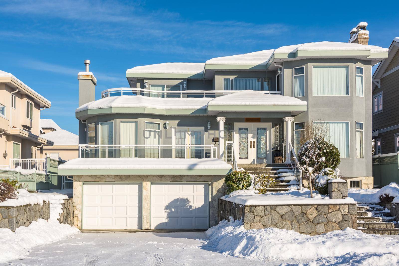 Big luxury residential house in winter season. North American family house on winter sunny day