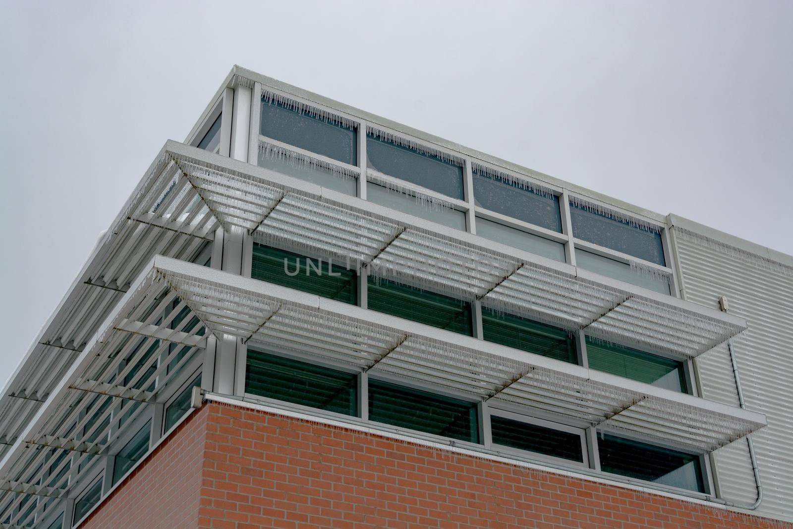 Icicles of freezing rain over window weather shelds of an office building in British Columbia, Canada