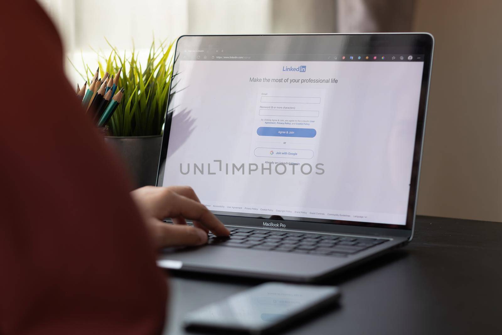 CHIANG MAI, THAILAND, APR 10, 2021 : A woman using macbook pro with LinkedIn on the screen.LinkedIn is a photo-sharing web.