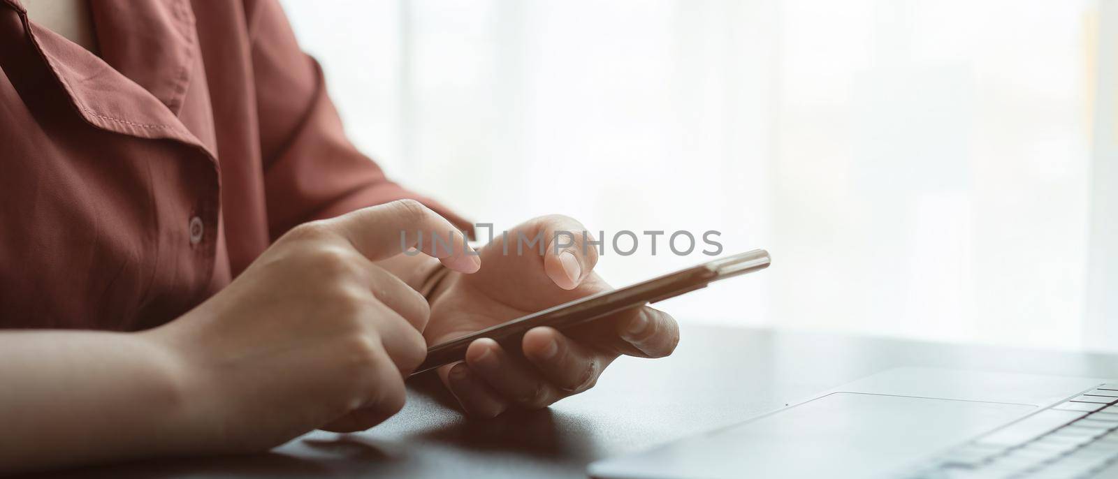 Close up hand of woman using smart phone.