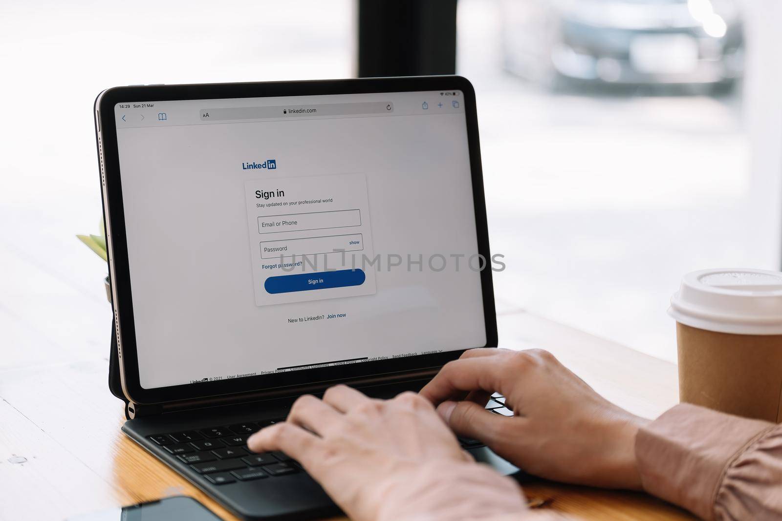 CHIANG MAI, THAILAND, MAR 21, 2021 : A woman using iPad Pro with LinkedIn webpage on the screen.LinkedIn is a photo-sharing web