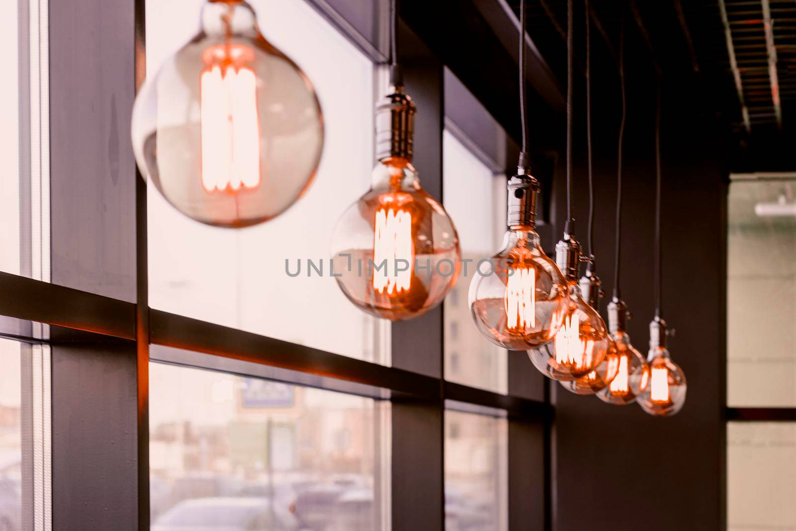 Decorative lamps in retro style in a row. Side view, indoors horizontal shot. by Essffes