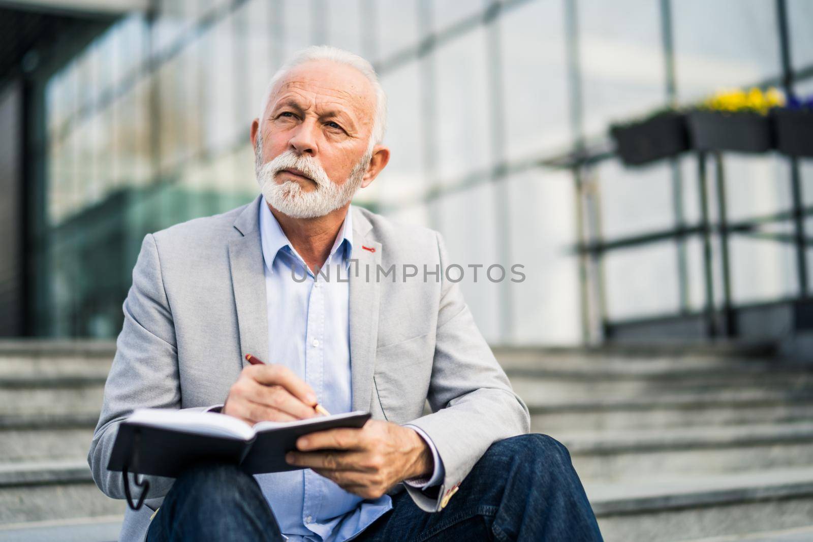 Senior businessman is pensive. He is thinking about his schedule.
