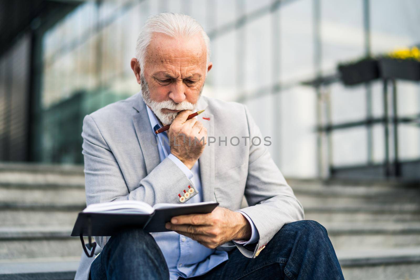 Senior businessman is pensive. He is thinking about his schedule.