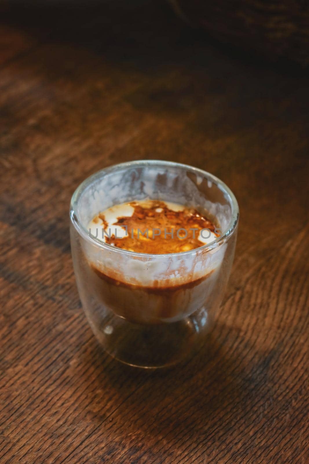 iced dirty coffee on wood table by baworn47