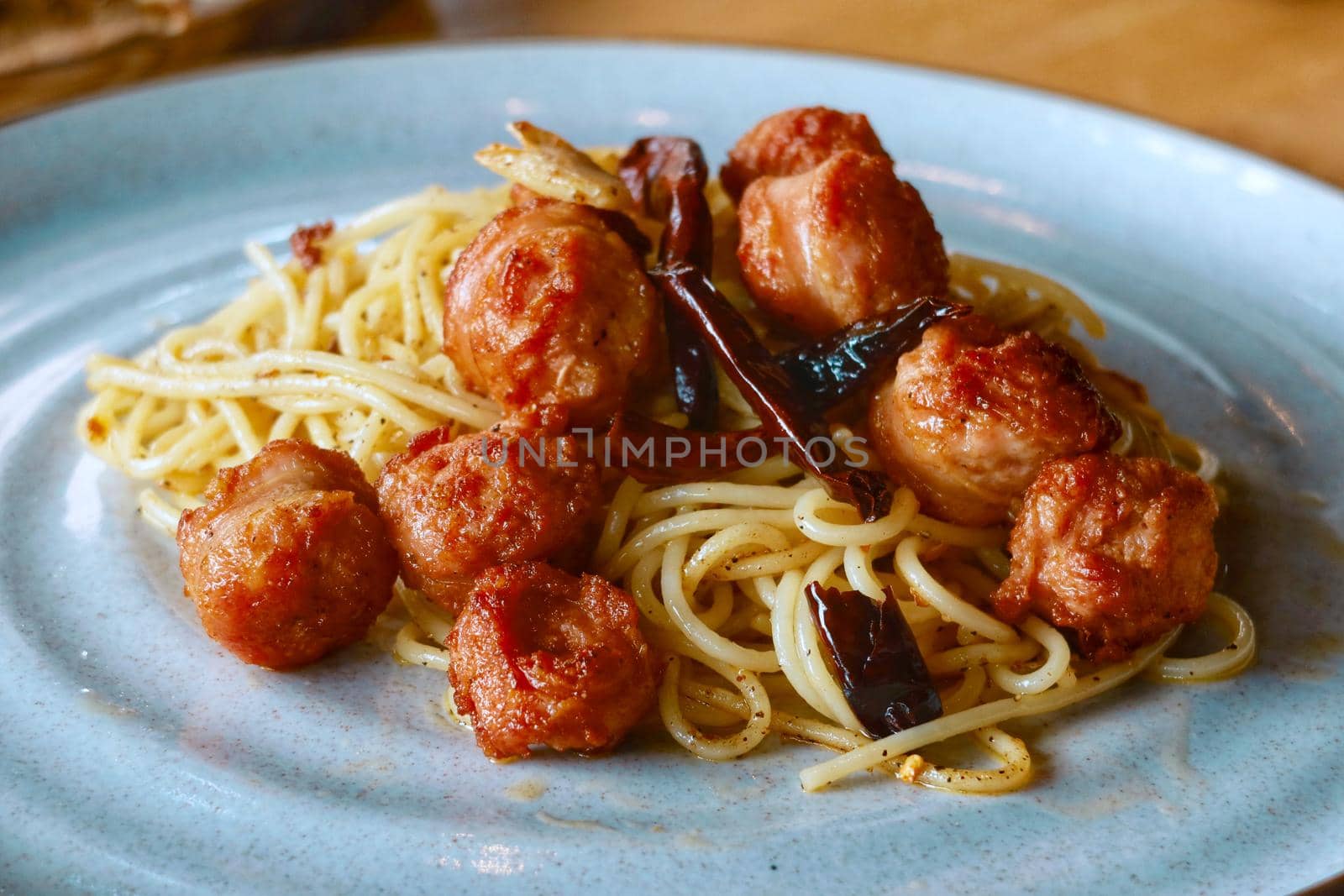 closeup spicy spaghetti italian sausage in thai style by baworn47