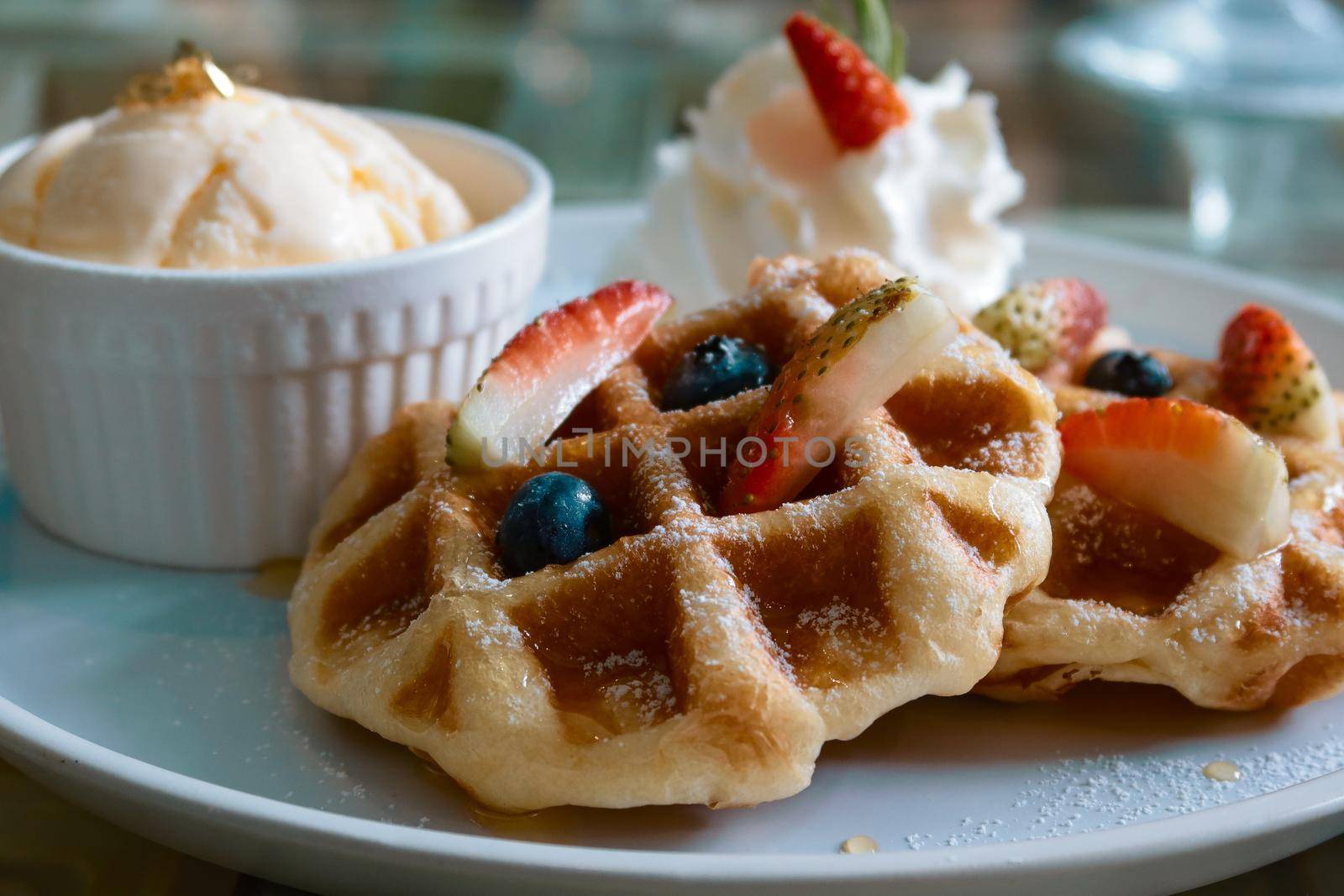 closeup butter waffle with strawberry and vanilla ice cream by baworn47