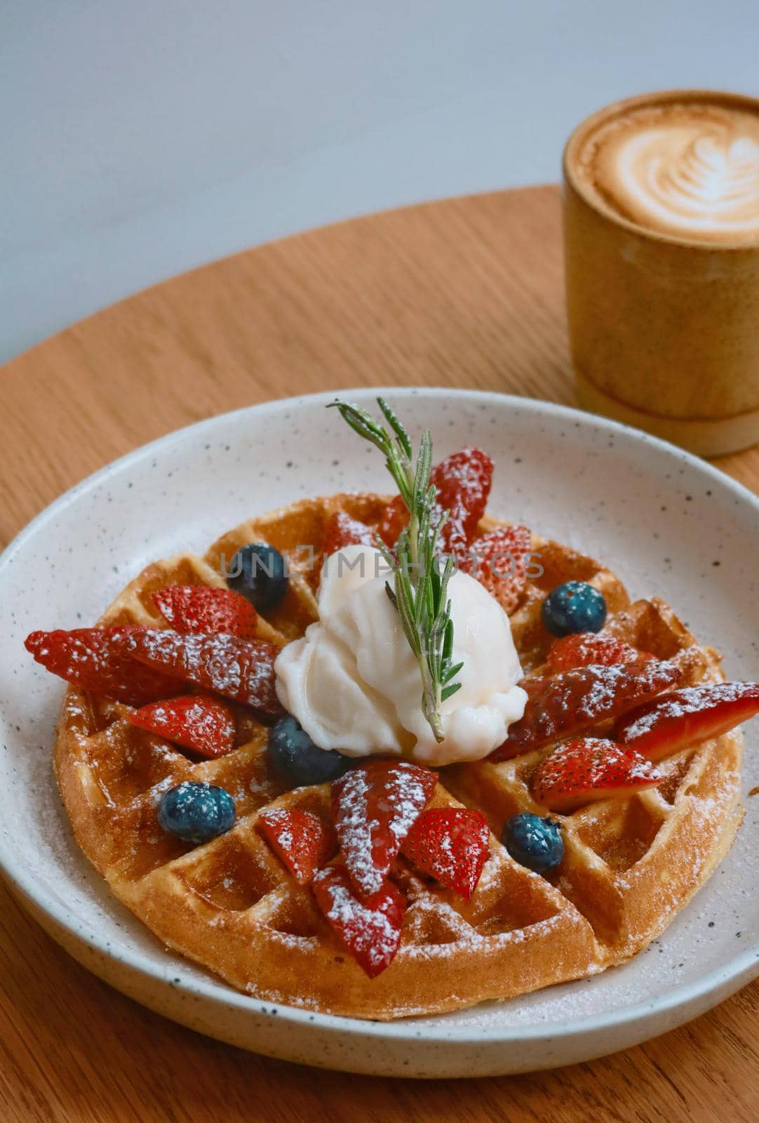 top view of mixed berry waffle with icecream and hot coffee background